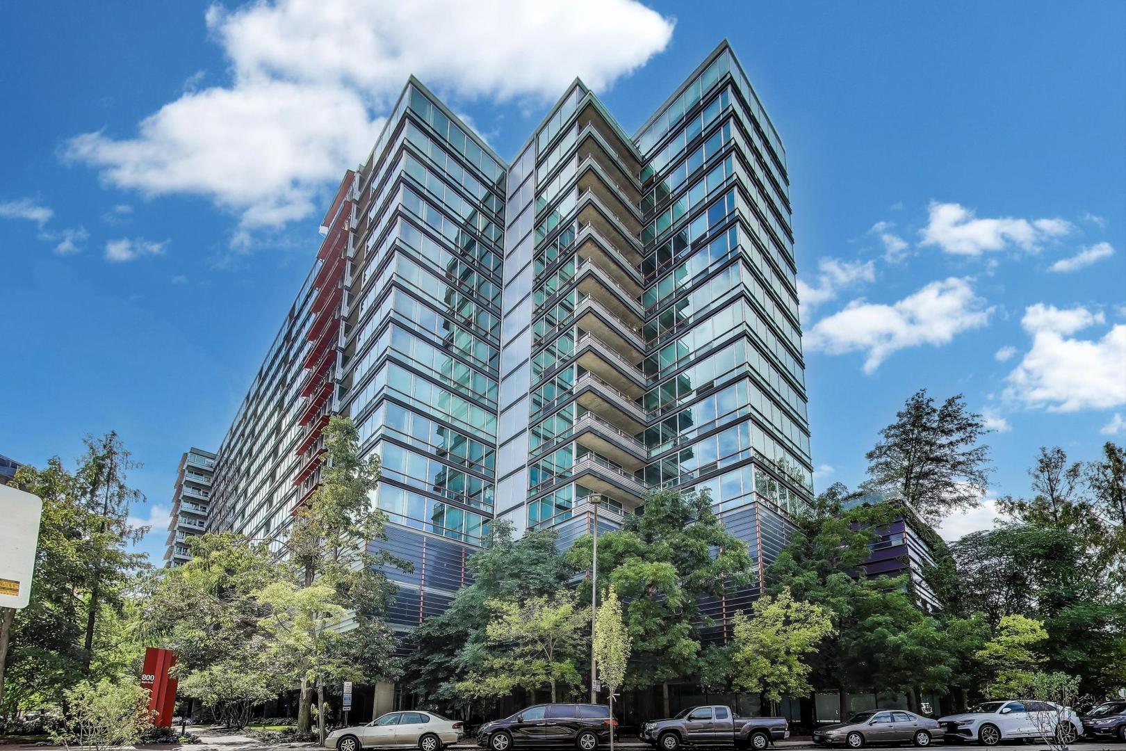 Welcome home to the largest 2-bedroom, 2-bath floor plan at Optima Horizons, offering 1,268 square feet of beautifully designed living space, an inviting eastern exposure, and peaceful tree-top views. A thoughtful split-bedroom layout provides privacy, while the spacious floor plan offers exceptional flexibility with a generous living area plus a versatile den/dining room-ideal for entertaining, working from home, or creating a comfortable retreat. Oak flooring flows throughout, complemented by a neutral color palette that creates a warm, serene atmosphere. The well-appointed kitchen features granite countertops, ceramic tile flooring, and stainless-steel appliances, while ample closet space provides excellent storage. Dual-zoned central heating and air conditioning ensure year-round comfort. Step outside to your private balcony and enjoy a tranquil tree-top setting with views toward the Northwestern University campus and glimpses of the lake, particularly beautiful in the fall and winter months. Two garage parking spaces and a private storage unit complete this exceptional offering. Optima Horizons is a full-amenity, pet-friendly building with full-time door staff, indoor pool, fitness center, sun deck and garden terrace with grills, and professional management. Perfectly situated just blocks from Northwestern University, the lakefront, bike paths, Metra, shopping, restaurants, and theaters, this move-in-ready residence puts the best of Evanston right outside your door. Spacious. Serene. Exceptionally located. Welcome home.