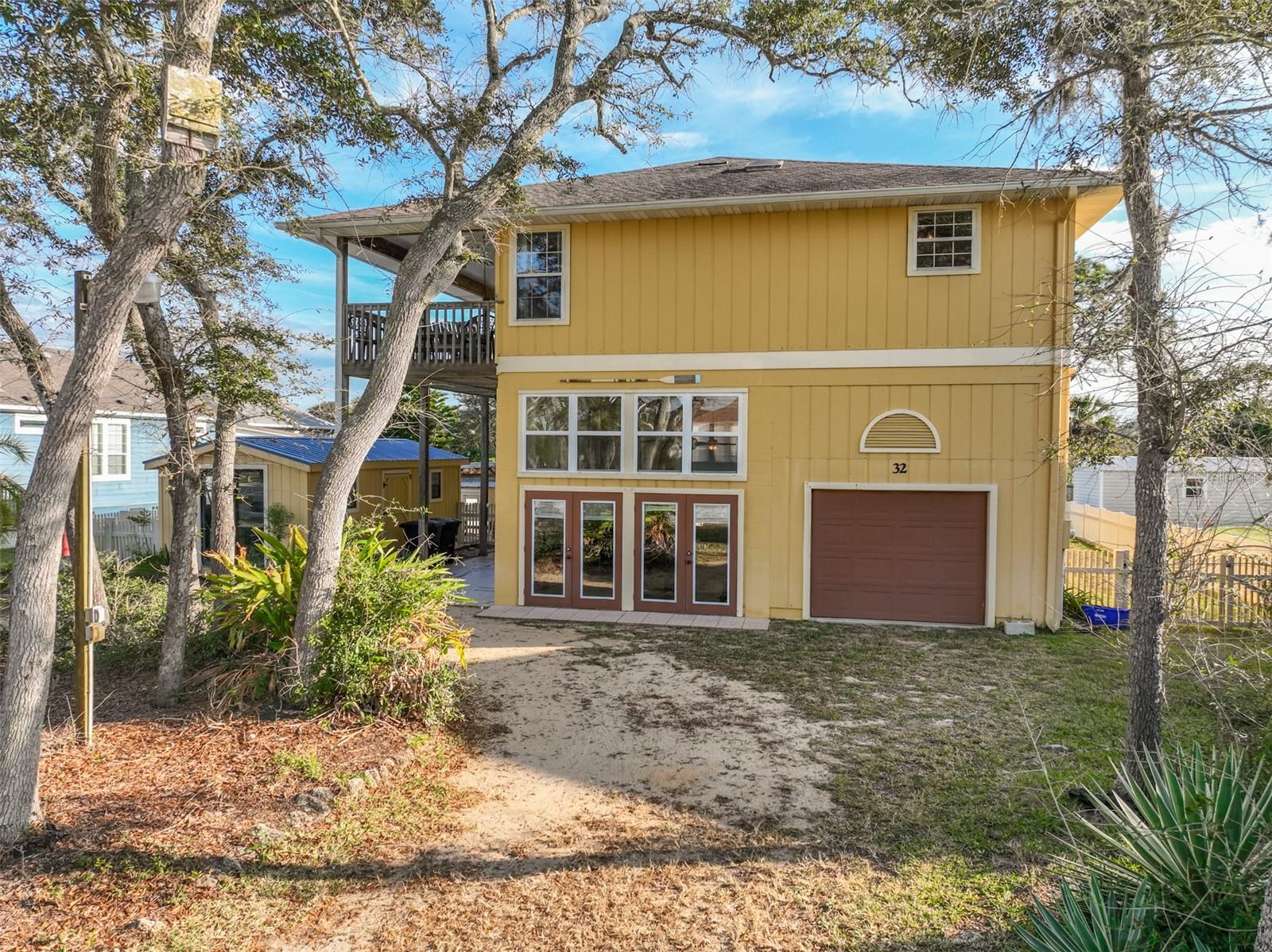 Short Sale. This charming two-story “Old Florida” style home offers the perfect beachside retreat in Palm Coast’s highly desirable Hammock community. Relax on the inviting front porch and enjoy the gentle ocean breezes, or head out for a short walk, bike ride, or golf cart trip to nearby public beach accesses. A private, deeded access is also just a few blocks away, leading to one of the area’s most beautiful and uncrowded stretches of shoreline.Located in one of the few neighborhoods that permit short-term rentals and allow boat/RV parking, this property presents an excellent opportunity for a turn-key rental with immediate income potential. The home features a newer heat pump, a whole-house water filtration system, and a spacious kitchen equipped with stainless steel appliances, marble tile countertops, an undermount sink, and convenient island seating.Enjoy the relaxed coastal lifestyle with popular local restaurants and amenities just moments from your doorstep!