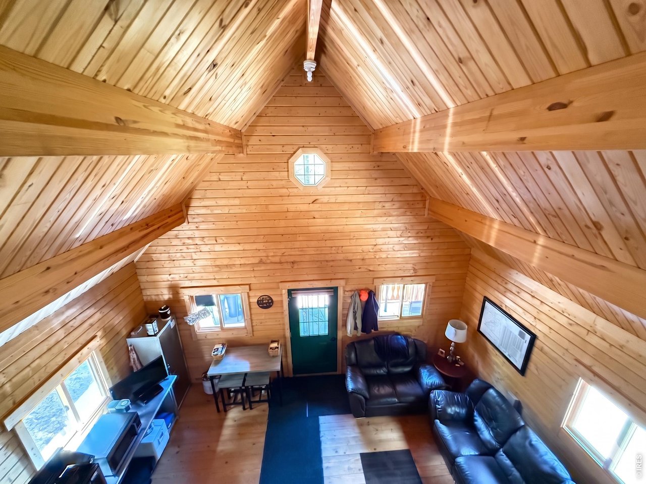 Escape the noise and secure your piece of the Colorado wilderness. Located in the exclusive Moose Haven enclave-a rare private inholding surrounded by Roosevelt National Forest-this 35-acre offering brings a level of privacy that is becoming impossible to find. The 900 sq. ft. craftsman cabin is designed for both comfort and rugged independence. Featuring soaring vaulted ceilings and a central woodstove, the open-concept layout is the heart of the cabin. With two dedicated bedrooms on the main level, plus a versatile loft, the cabin comfortably hosts large groups for seasonal retreats or extended backcountry stays. This is a turn-key transition. The infrastructure is ready for a modern off-grid living setup with a generator-ready electrical system and dedicated cistern water storage. Whether you're seeking a summer sanctuary or a basecamp for hunting and hiking, this is more than a cabin-it's a mountain legacy. No direct neighbors, no distractions, just untouched access to surrounding wilderness.