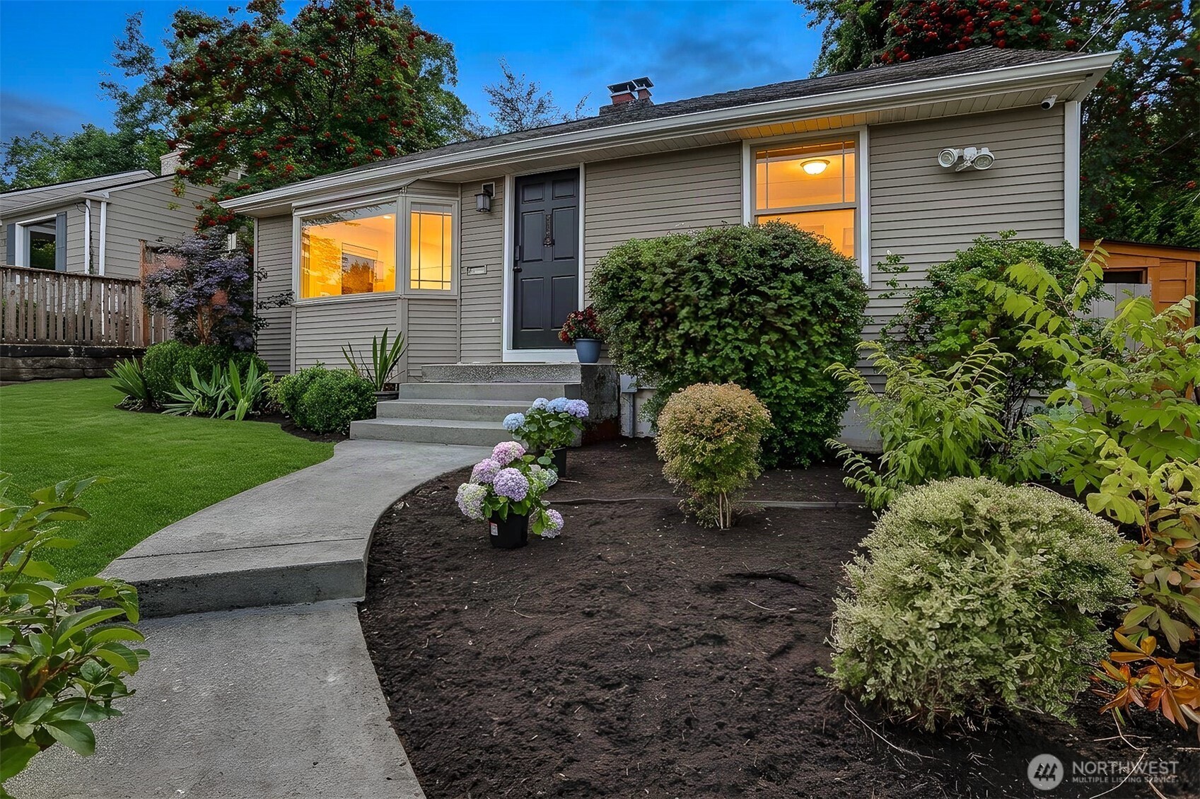 Welcome to this beautifully renovated Magnolia home, thoughtfully updated with quality finishes and everyday convenience in mind. As you step through the front door, you’ll be greeted by gorgeous new hardwood floors and an abundance of natural light. The inviting living room features lovely territorial views, charming built-ins, and a cozy wood-burning fireplace, creating the perfect space to relax and unwind. The stylish, newly updated kitchen showcases quartz countertops, newer stainless-steel appliances, and a sliding glass door that opens to the back deck, making indoor-outdoor living and entertaining a breeze. Step outside to your own private backyard oasis. A gardener’s dream, the beautifully landscaped yard features terraced garden beds and a lovely deck ready for summer gatherings or morning coffee.Two spacious bedrooms and a newly renovated bathroom complete the main level. Downstairs, a cozy family room with brand-new carpet offers the perfect setting for movie nights or casual gatherings. A third bedroom and generously sized office—both with new carpet—provide plenty of flexibility for guests or work-from-home needs. A brand-new second bathroom with designer finishes and a large laundry room complete the lower level. For added convenience, the home also includes your own personal EV charger on the street. VA loan is assumable at 3.5% interest rate. This move-in-ready home combines thoughtful updates, timeless charm, and modern functionality in a wonderful setting.