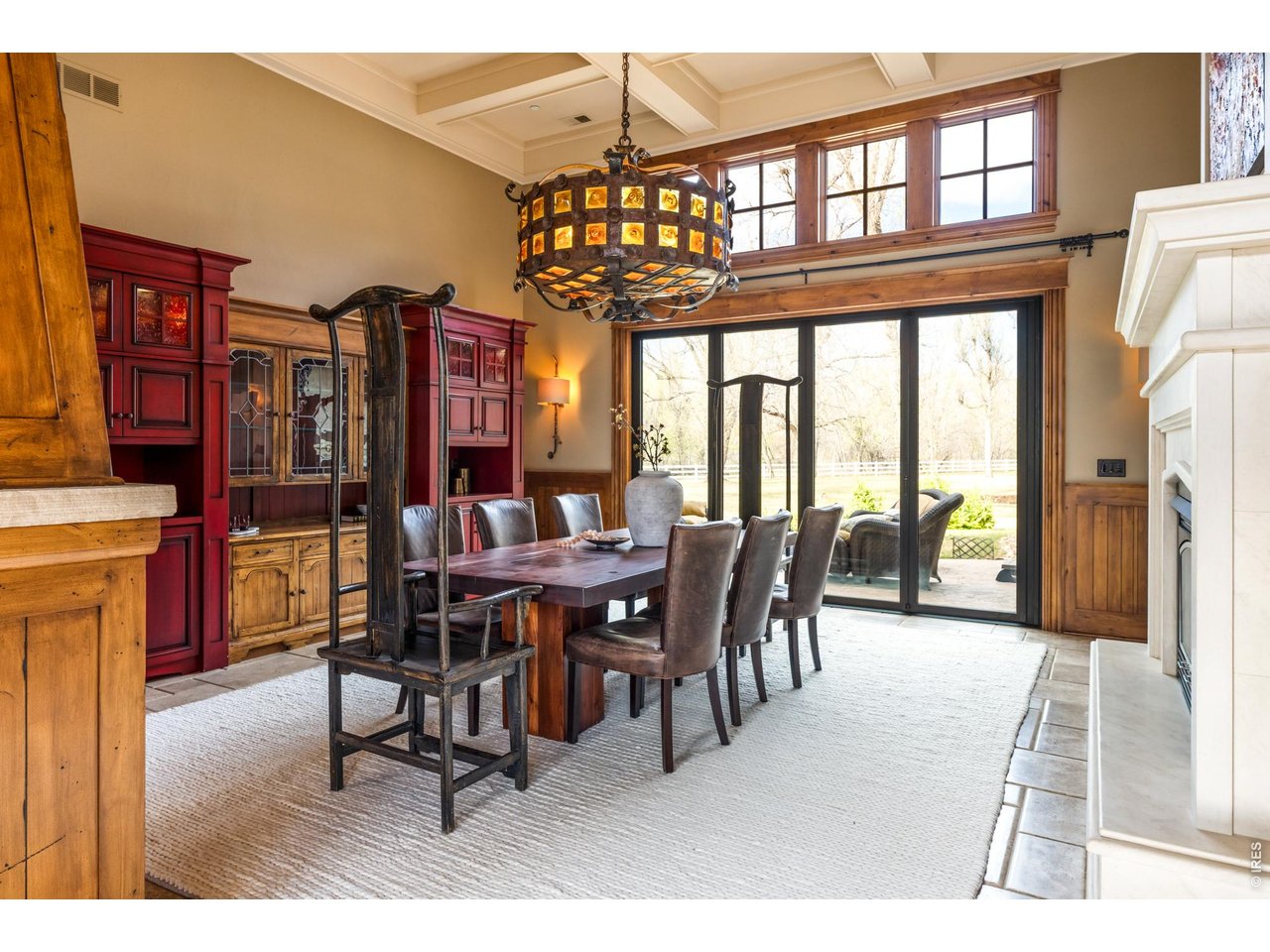 Perched along a coveted stretch of the St. Vrain River is the unparalleled Crosswinds Ranch: an extraordinary multi-residence legacy estate encompassing nearly 20 acres of resort-caliber grounds. Rare senior water rights, a productive hay field and a pond complement the property's flexible agricultural and equestrian utility; crafting a luxurious combination of recreation, multi-use living and agronomic functionality. The estate is composed of three distinct residences - a grand main residence, a restored Edwardian farmhouse teeming with historic legacy and a renovated guest house designed as a single-level wellness retreat. Inside the main residence, expansive entertaining spaces are complemented by fold-out sliding doors that seamlessly connect indoor and outdoor living areas. Recent upgrades include new carpeting, custom stonework, dual aquariums and luxury bidet installation. The 3,200-square-foot, 3-bedroom guest house includes a private office and separate outbuilding, while the farmhouse boasts a detached garage, creating exceptional flexibility for collectors, hobbyists, equestrian pursuits or recreational storage. Curated for both large-scale entertaining and everyday use, the expansive grounds include three private pickleball courts, a full basketball court, leisure pool, lap pool, hot tub, cold plunge, custom outdoor kitchen and multiple fire pit lounges surrounded by professional landscaping and buff stone decking. Solar pool heating and expanded guest parking further elevate the experience. The grounds have been extensively enhanced with upgraded irrigation systems, pond improvements, dual septic systems and a private orchard featuring 125 mature apple and pear trees. An integrated audio/video/security system with whole-property camera coverage provides peace of mind throughout the compound. Framed by open skies and the tranquil rhythm of the river, Crosswinds Ranch is a rare offering where privacy, scale and resort-inspired living converge.