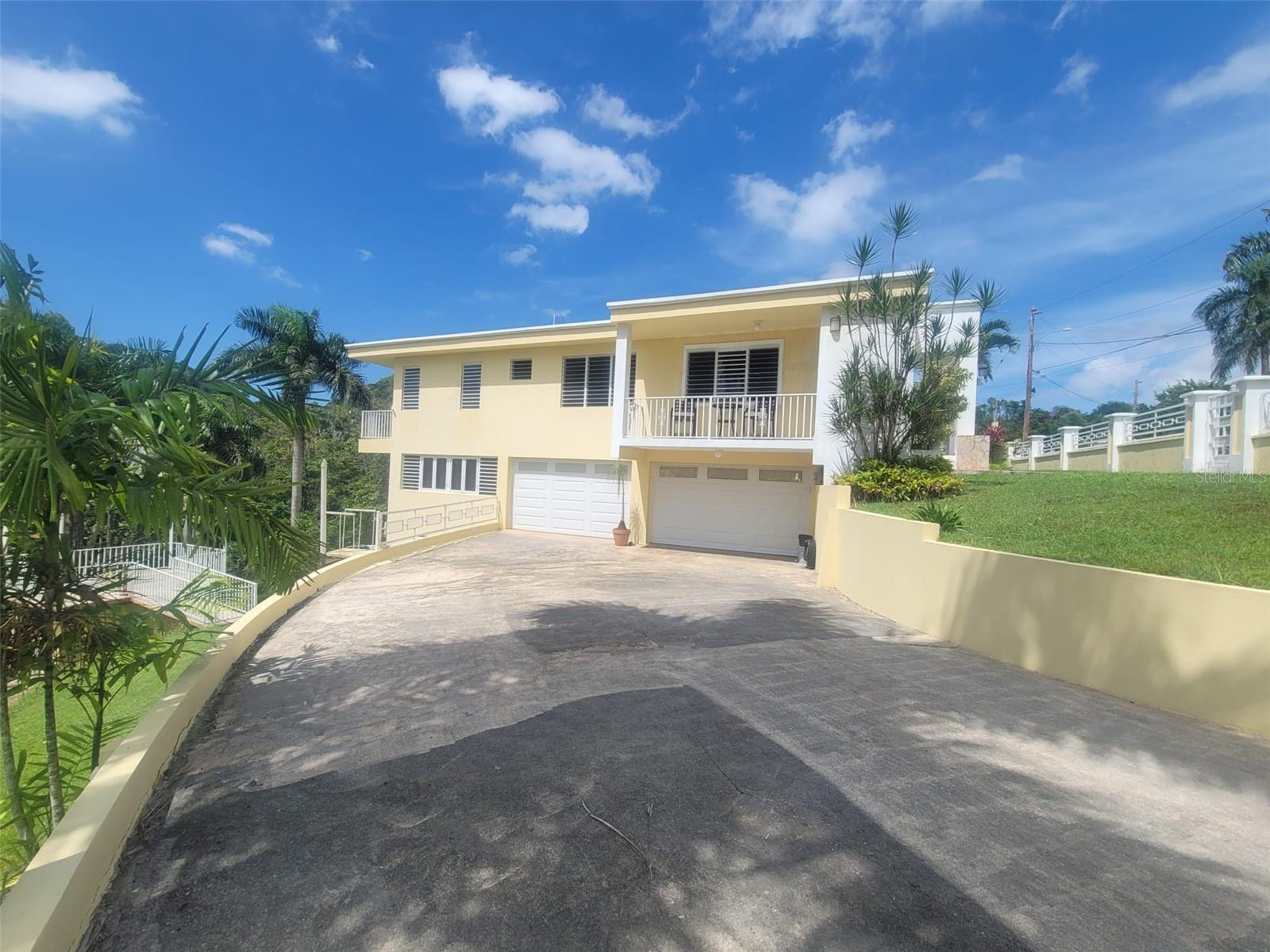 Property for sale in Hacienda del Dorado, Dorado, Puerto Rico. Residence on a large 3,947 sq. meter lot offering 2,500 sq. ft. of living space and excellent layout for primary residence use. Located in a gated community with 24-hour security and strong access to main roads in Dorado.The property features 4 bedrooms and 2.5 bathrooms, with a functional distribution including living room, dining area, kitchen, laundry, and a welcoming foyer. A double carport provides covered parking for up to 4 vehicles. The home is in good condition, offering a solid structure ready for immediate occupancy.A key feature is the lower level, which includes two separate spaces already prepared with plumbing and electrical infrastructure, offering potential for future conversion into additional living units or flexible use areas.The large lot provides privacy, outdoor space, and expansion possibilities within an established and well-located community.