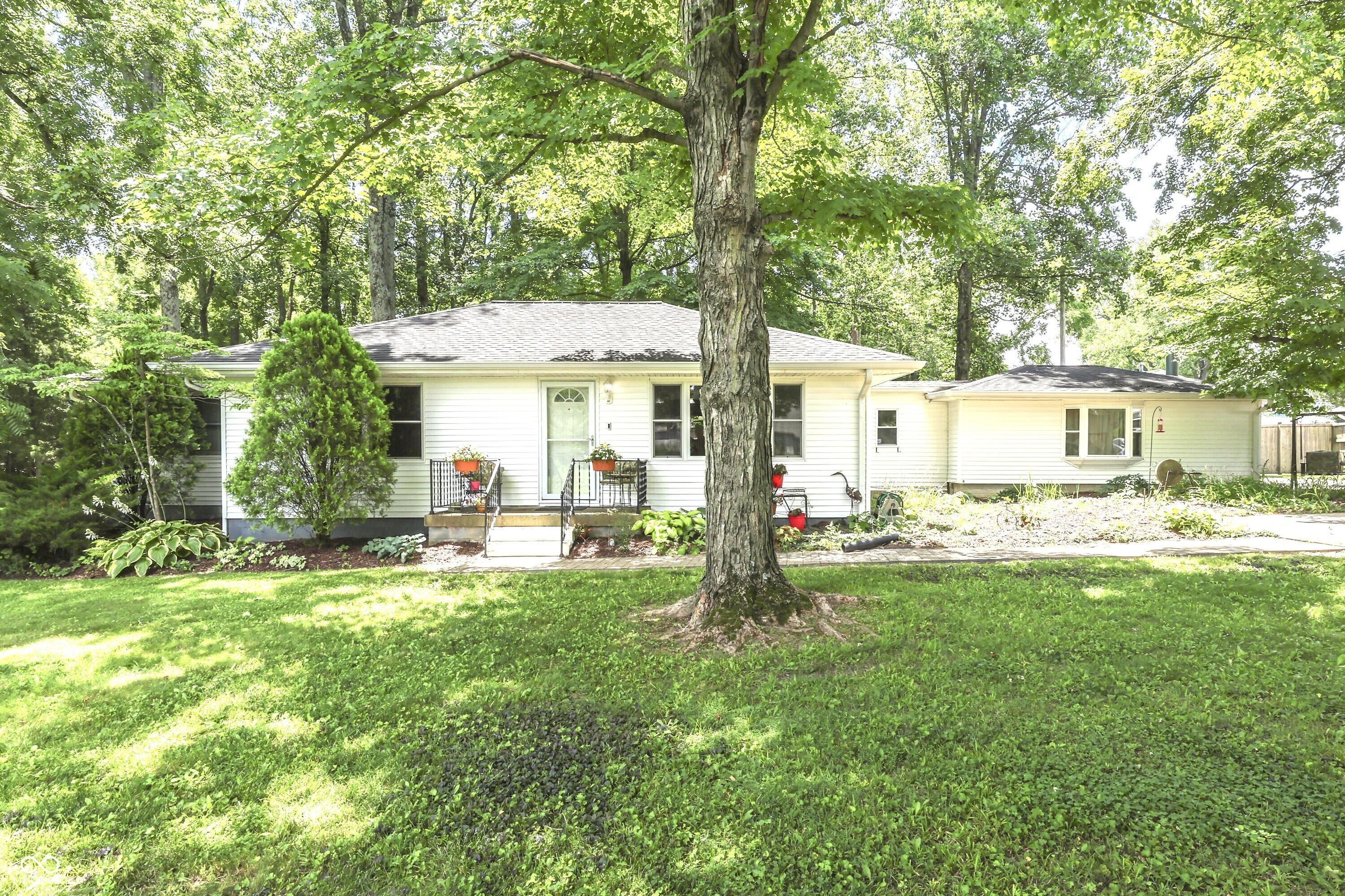 Calling All Grease Monkeys and Wood Workers!! If you have been looking for your own Little Slice of Heaven...your own Solitary Oasis, then we've got it for you right here. Sitting on 1.4 Acres, just a little South of Center Grove High School and West of Morgantown Road, this is Absolutely Gorgeous!! No HOA, just nothing but Mature Trees, Singing Birds and Serenity all the way around. The house itself has 1,800 square feet, 3 Bedrooms, 2 Bathrooms and Heated Floors under the Main Bathroom which you will LOVE this winter. And the Kitchen is so Warm and Cozy and Highly Functional, too Complete with Custom Ash Cabinets and Brazilian Cherry Drawers. The Kitchen Floors are a Gorgeous Slate and the Dual Fuel, Double Oven has Extra Gas Burners on Top combined with an Electric Oven for the Best of Both Worlds and All Stainless Kitchen Appliances are Included. There are Soap Stone Countertops which can handle any kind of heat you place on them. There's also a HUGE Center Island with TONS of Storage and a Soap Stone Farmers Sink, too. In the Eating Area, you will find Additional Storage, Beautiful Built-Ins and an Over-Sized Buffet - Perfect for Serving Large Crowds and the Countertops on that are made of Walnut with Curly Maple Trim. The Vaulted Ceilings in the Kitchen and Eating Area and all of the Gorgeous Woodwork will make you feel like you've just stepped into a Cabin in Gatlinburg - It is truly One of a Kind. Outside you've got a Large Deck, a Hot Tub and a Bridge crossing over the Creek into your very own Park Like Setting. Mature Trees everywhere you look and a Fire Pit, too. And...can you believe this...there is a 7 Car Garage/Workshop Area!! Complete w/ Concrete Floors Underneath a 3/4in 2x2 Pressed Wood Sub-Floor Membrane Panel, 10 Foot Ceilings, Heat and Air.  You know who you are that has been looking for a property just like this one and you also know they don't come along very often. This one is Truly One of a Kind and Will Not Last - MUST SEE TODAY!