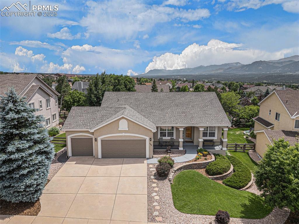 Welcome to this beautifully maintained ranch-style home offering true main-level living and sweeping Front Range mountain views. Thoughtfully designed with comfort and functionality in mind, this 4-bedroom, 3-bathroom home features rich hardwood floors, newer carpet, and a layout ideal for both everyday living and entertaining. The main level boasts vaulted ceilings, a spacious living room with a cozy gas fireplace and direct access to a composite deck—perfect for enjoying Colorado sunsets. A dedicated office and formal dining room offer flexible space for work and gatherings. The kitchen is ideally positioned at the heart of the home, adjacent to the living and dining areas. Retreat to the generous main-level primary suite, complete with a 5-piece bath and an ample walk-in closet. Downstairs, the walk-out basement provides a second living space with another gas fireplace, a wet bar, full bath, and two additional bedrooms—ideal for guests or multigenerational living. There's also a large unfinished area, perfect for storage, hobbies, or future expansion. Outside, enjoy a beautifully landscaped backyard that backs to peaceful walking trails, offering privacy and nature just steps from your door. Additional updates include newer exterior paint and roof! Don't miss this rare opportunity to own a move-in-ready home with breathtaking views, flexible space, and access to everything Monument has to offer.