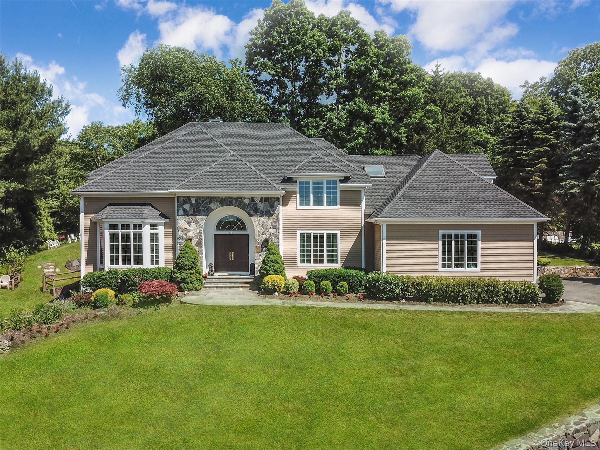 Spectacular and turnkey center hall Colonial in the desirable Random Farms community within the highly coveted Chappaqua School District. Perched atop a hill, this home enjoys sweeping views and breathtaking sunsets from a private setting. Boasting 5 spacious bedrooms and 4.1 baths across three beautifully finished levels, this home offers 5,792 sq ft of beautifully designed living space, filled with natural light and featuring an open floor plan ideal for both entertaining and relaxed family living. The home showcases soaring ceilings, newly refinished oak hardwood floors, a thoughtfully updated eat-in kitchen with granite countertops and stainless steel appliances, seamlessly flowing into the breakfast room and inviting family room. Numerous recent updates include a new roof, new HVAC system, freshly stained interior and exterior, and a full lawn sprinkler system. Special highlights include two staircases, a private main-level office, and a luxurious primary suite with dual walk-in closets. Architectural details such as skylights and elegant archways add character throughout. The oversized garage provides additional storage, while the main-level mudroom and back staircase enhance everyday convenience. The walk-out lower level is designed for versatility and fun, offering an expansive entertainment and recreation space complete with a wet bar, bedroom (ideal for guests or a nanny), full bath, laundry, and finished storage. The oversized garage provides additional storage, while the main-level mudroom and back staircase enhance everyday convenience.  Set on a beautifully designed multi-level backyard with sitting areas and play space, this property is sure to please.  A rare opportunity to own a stunning move-in ready home in one of the area’s most desirable communities.
