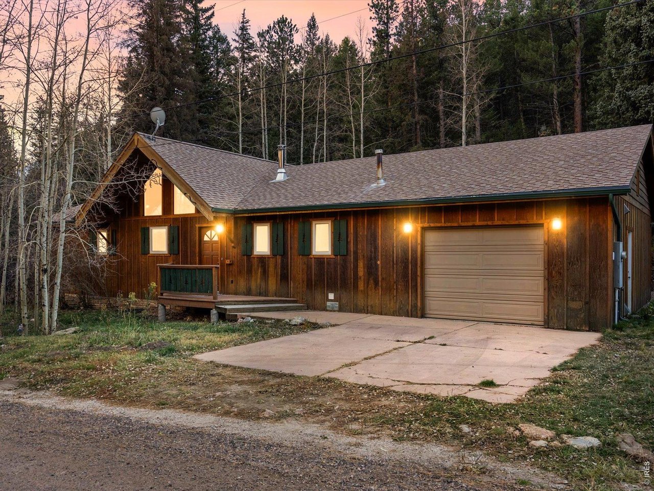 Turn off the road, let the trees close in, and listen, that's a stream running right through your own backyard. This 2-bed, 2-bath cabin wraps 1,614 square feet of mountain comfort around a soaring, light-filled great room where big windows pull the forest indoors. Cook in a kitchen with room to spread out, stay cozy under quiet radiant heat, and enjoy the everyday ease of an attached garage and in-unit laundry. Then step onto the spacious deck, where the sound of moving water and open sky take over. Full-time retreat, weekend escape, or turnkey rental, homes with true creek frontage and this kind of peace don't last. Come hear the stream for yourself.
