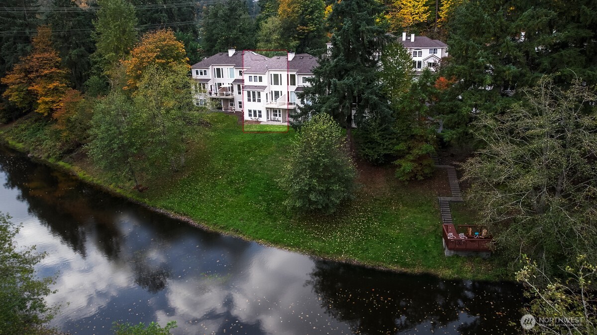 Beautifully situated along the Sammamish River, this Bothell home offers a rare blend of comfort, style, and location. The main level features an open kitchen with newer stainless-steel appliances, hardwood flooring, and a light-filled living area with skylights and direct access to a private balcony overlooking the river. Upstairs, two spacious bedrooms each offer en-suite baths and generous closets. The daylight basement includes a third bedroom, full bath, wet bar, and a versatile bonus room ideal for guests, office, or media space. Enjoy private river access just steps away, surrounded by miles of walking and biking trails, with easy access to downtown Bothell, parks, shopping, and major commuter routes.