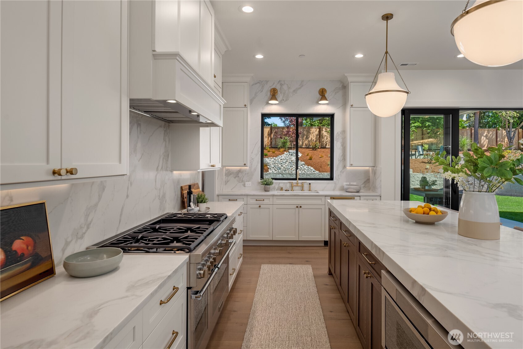 Professional-grade gas range flanked by marble counters