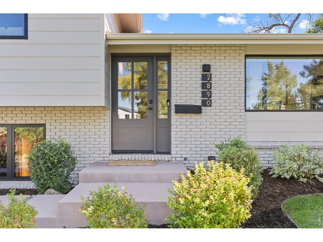 Thoughtfully remodeled and move-in ready, this Table Mesa North home pairs quality craftsmanship with warm, modern design in an exceptional Boulder setting. Located on a quiet street with a striking Flatirons backdrop, it offers easy access to scenic trails and the shops and restaurants of Table Mesa.Vaulted ceilings and wide-plank oak floors create an inviting main living space, anchored by a spacious kitchen island with brass pendant lighting. The open layout connects cooking, dining, and gathering, while a wood-burning fireplace with a custom steel surround adds warmth and character. Marvin windows and doors frame the surroundings and connect the dining area to the backyard patio.Outside, a generous flat, grassy yard and thoughtfully designed landscaping-including grading, irrigation, and drainage-provide space to relax, play, and entertain. The attention to detail extends behind the scenes, with upgrades including buried 200-amp electrical service, new driveway/patio/entry, and all new mechanicals (2024 and humidifier in 2025). Upstairs, the primary suite enjoys Flatirons views and a beautifully finished bath with Carrara marble, limestone flooring, and a spacious shower. Two additional bedrooms offer flexibility for guests or working from home. The lower level features a comfortable media or game room, an additional bedroom, laundry, and a mudroom connecting to the two-car garage. A separate heated and cooled bonus room behind the garage offers additional space for a gym, office, or creative pursuits.With nearby schools, access to the Enchanted Mesa trail, and convenient shopping and dining at Table Mesa Shopping Center, this home brings together thoughtful design and the South Boulder lifestyle.
