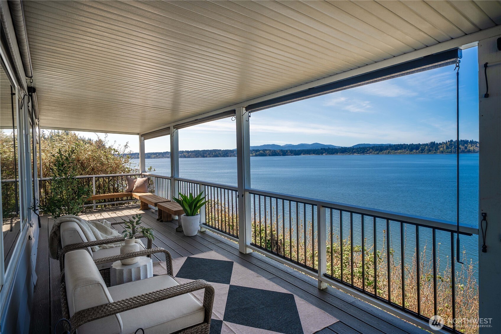 Imagine waking up to sunrises over the water, spending your mornings on the wraparound deck, and ending your day with glowing sunsets from your living room. Inside, the open-concept layout is filled with natural light and designed to cook, dine, and relax—all with breathtaking Puget Sound & Olympic Mountain views as your backdrop.    Custom remodeled kitchen features an oversized island with seating, granite countertops, stainless steel appliances, deep drawers, and a walk-in pantry. A flexible office/den also captures the view, while the spacious guest bedroom and full bath provide comfort for visitors. The primary suite offers dual closets, including a large walk-in, and a fully updated bath with a tile walk-in shower and elegant barn-style sliding glass doors.    Step outside to the expansive wraparound deck or retreat to the incredibly private side yard with custom planting shelves—perfect for gardening or entertaining with water views. Additional highlights include 3-car covered parking and two storage sheds.    Head down to the private beach for kayaking, beachcombing, or peaceful walks with your dog, and enjoy community amenities including a heated outdoor pool, clubhouse with activities, and walking trails. Located in the sought-after 55+ community of Seashore Villa—this is more than a home, it’s a lifestyle.