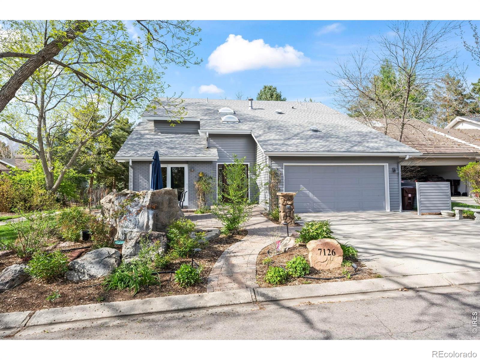 Discover luxurious, low-maintenance living just steps from the Boulder Country Club golf course, clubhouse, fitness center, pool, and pickleball courts. Ideally situated on lush HOA-maintained greenbelts with scenic walking paths and ponds, this elegant PATIO HOME offers both front and rear patios designed for relaxing outdoors or effortless summer entertaining. Inside, timeless architecture blends with sophisticated modern updates and an open-concept layout. Expansive living and dining spaces are highlighted by vaulted ceilings, picturesque windows, cozy gas fireplace, and multiple sliding doors that create a seamless indoor-outdoor connection. The chef-inspired kitchen is thoughtfully appointed with premium appliances, including a Viking gas range and hood, Dacor oven with warming drawer, Sub-Zero refrigerator, beverage fridge, custom cabinetry, solid-surface countertops, and stone backsplash. A rare main-level bedroom suite provides convenient, handicap-accessible living with an ensuite bath featuring radiant heated floors and a spacious walk-in shower. Upstairs, the luxurious primary retreat boasts vaulted ceilings, a private balcony, gas fireplace, and spa-like 5-piece bath with dual vanities, jetted soaking tub, and oversized steam shower. The custom walk-in closet includes built-in organization and direct access to the laundry room with included washer and dryer. An additional upper-level bedroom and bath offer ideal space for guests, family. The unfinished basement presents endless possibilities for future expansion-whether envisioning additional living space, a home theater, fitness studio, golf simulator, or exceptional storage.