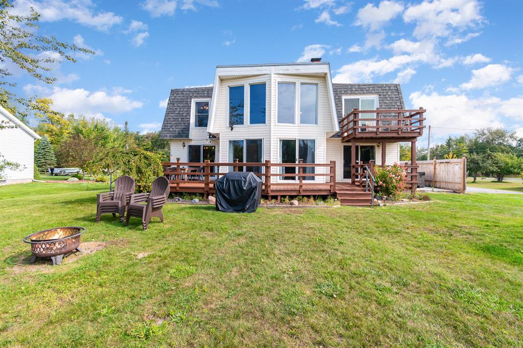 NEW AC, water heater, and heating system.This channel-front home offers direct access to Lake Huron, a private dock, and a proven short-term rental history. With 3 bedrooms, 2 bathrooms, and 1,900+ finished sq ft, it's sold fully furnished and currently operating as a successful, cash-flowing Airbnb--ready to continue as an investment or be enjoyed as a personal summer retreat.Outdoor living is a key feature, with a large back deck overlooking the channel and an upper-level primary suite with a private balcony--ideal for morning coffee or evening downtime. Easy boating access, strong rental appeal, and major mechanical updates already completed make this a low-maintenance, high-utility waterfront property.