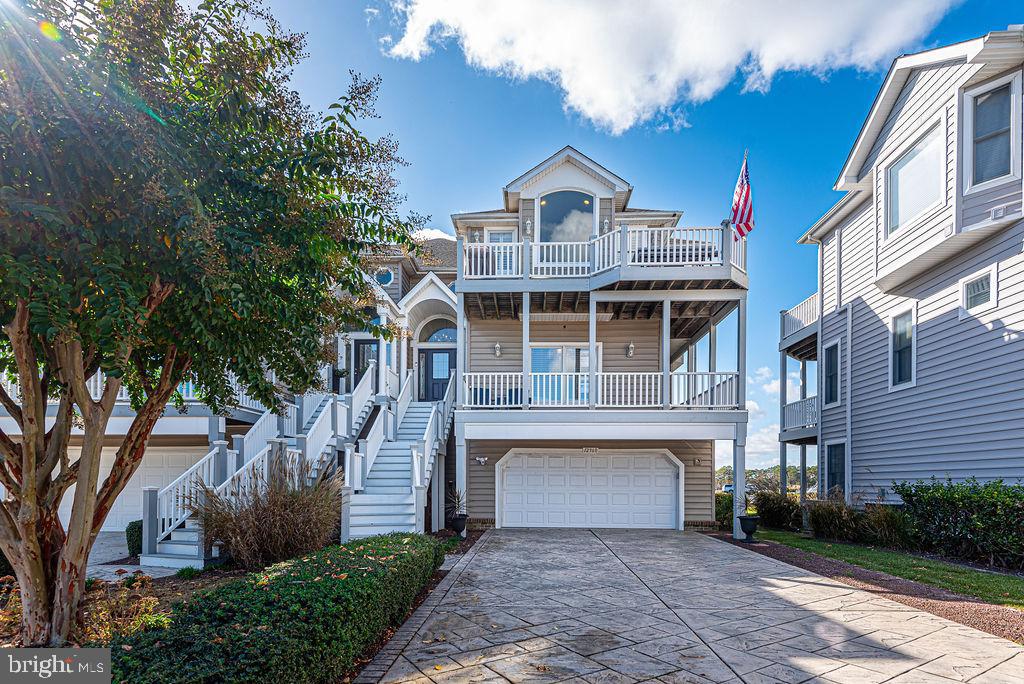 Located in the premier waterfront community of Marsh Harbour at **12960 E Hopetown Ln #A3**, this immaculate 3,475 sq. ft. end-unit townhome offers exceptional bayfront living in West Ocean City. Showcasing breathtaking bay and pond views, the home features 5 bedrooms and 3.5 baths, including a convenient ground-level secondary entrance that leads to a private captain’s quarters—perfect for guests or multi-generational living. The expansive main living space is filled with natural light and features a cozy fireplace framed by custom-built-in cabinets and shelving, seamlessly connecting the updated gourmet kitchen, generous dedicated dining area, and access to multiple outdoor decks—perfect for entertaining and enjoying indoor-outdoor living. The kitchen boasts a large center island, high-end finishes, and an open layout that enhances the home’s spacious, coastal charm. This exceptional residence also includes an oversized two-car garage and an outdoor shower for beach days.  Boating enthusiasts will love the private deeded deep-water boat slip (Slip #33) with a 10,000 lb lift, accommodating up to a 36 ft boat and providing direct access to the inlet with no bridges to navigate. Enjoy easy boating to Assateague Island, the Ocean City inlet, and popular waterfront destinations like Harborside Bar & Grill, Sunset Grille, and the Ocean City Marlin Club. Community amenities in Marsh Harbour include a bayfront pool, clubhouse, fitness room, and professionally landscaped grounds with tranquil ponds and fountains. Best of all, this home is **not located in a flood zone**, so **flood insurance is not required**. Located minutes from renowned fishing marinas, the iconic Ocean City Boardwalk, and everything that makes this area the White Marlin Capital of the World, this home offers the ultimate in coastal luxury, low HOA fees, and no city taxes.