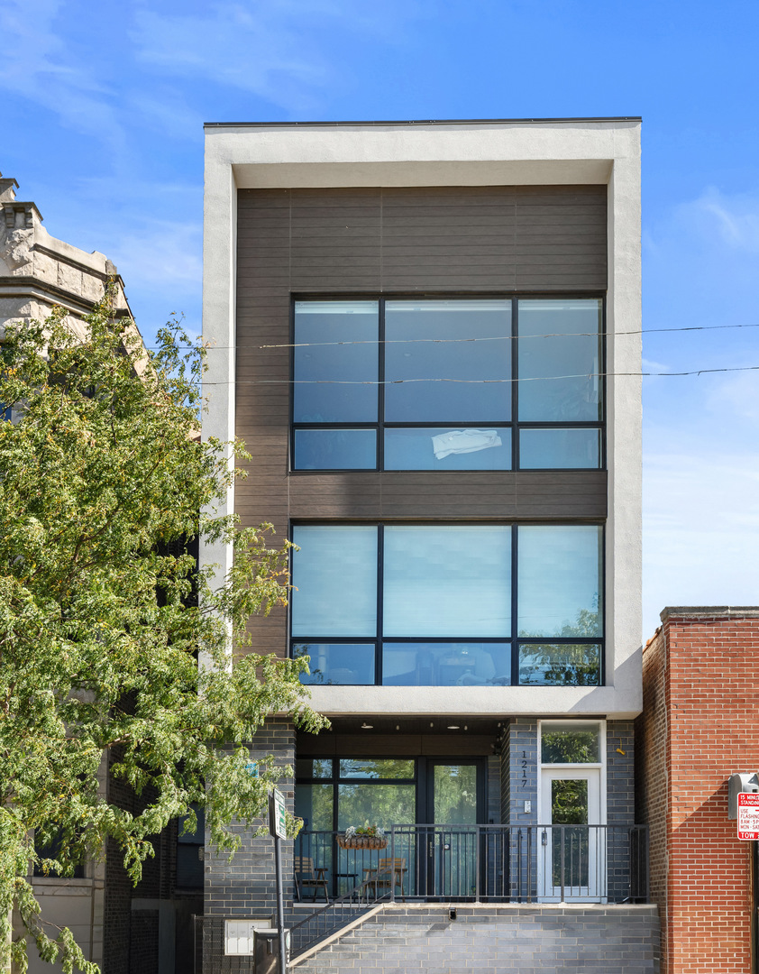 STYLISH + SPACIOUS IN PRIME WEST TOWN LOCATION!!    Live your best life in this extra-wide, modern duplex just steps from the vibrant heart of West Town! With 3 big bedrooms, 2.5 luxe baths, and a private entrance, this home brings serious style and comfort.  Inside, you'll find dreamy designer finishes-think sleek contemporary cabinets, quartz countertops, Bosch appliances, warm stained oak floors, and stunning 8' doors throughout. The spa-inspired primary bath is a total retreat with heated floors, steam + rain shower, and a double vanity. Oh, and TWO huge walk-in closets in the primary suite? Yes, please!  Downstairs? Full-size washer/dryer tucked away in a convenient laundry nook, and tons of built-out closet space to keep life organized.   EXTRAS, YOU BET; Private front terrace with park views - Common roof deck with jaw-dropping skyline views - Custom blinds throughout - Secure building with intercom + garage parking included.     And the location?  Just steps from buzzy Division Street dining + nightlife, and the epic 606 Bloomingdale Trail.  Move-in ready and calling your name!