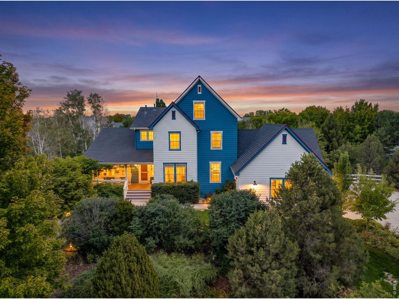 Set on a beautifully landscaped 0.88-acre lot, 9380 Cottonwood Circle offers a rare connection between gracious indoor spaces and extraordinary outdoor living. Mountain views, mature trees and natural light create a home that feels impressive and welcoming. A covered front porch introduces the home with warmth & charm. Inside, a bright, open entry with soaring ceilings and a beautiful staircase leads to a dedicated office, living room, formal dining room, renovated kitchen, family room & kitchen nook,, mudroom & laundry room. The family room opens to the kitchen, featuring an extended granite island with a built-in bookcase, double wall ovens, a five-burner gas cooktop and two Bosch dishwashers. A breakfast nook and balcony overlook the backyard and gardens. The second level offers a primary retreat with a sitting area and five-piece bathroom, plus two bedrooms sharing an updated bathroom. The third level features its own loft/retreat, bedroom and bathroom - ideal for guests, a studio or office. More than 70 mature trees - including apple, peach and plum - provide blossoms, fall color and privacy. Nine raised garden beds, berry patches, rhubarb and herbs create harvests spring through fall. The fenced lawn offers room to play or relax beneath the trees, with shaded patios and space for a pool. A garden shed adds storage, and the riding mower is included. The walkout lower level is an entertainer's dream, TV area, built-ins & a kitchenette plumbed for a second kitchen. The fifth bedroom pairs with a three-quarter bath, ideal for guests or multigenerational living, plus a workout area, craft room, library wall & storage room. The over-sized 3 car garage includes workbenches & storage. The home features surround-sound wiring for the family room, lower level & patio. The neighborhood offers a community park, open space and a walking path. This is more than a beautiful home - a place to gather, garden and enjoy the Colorado lifestyle for years to come.