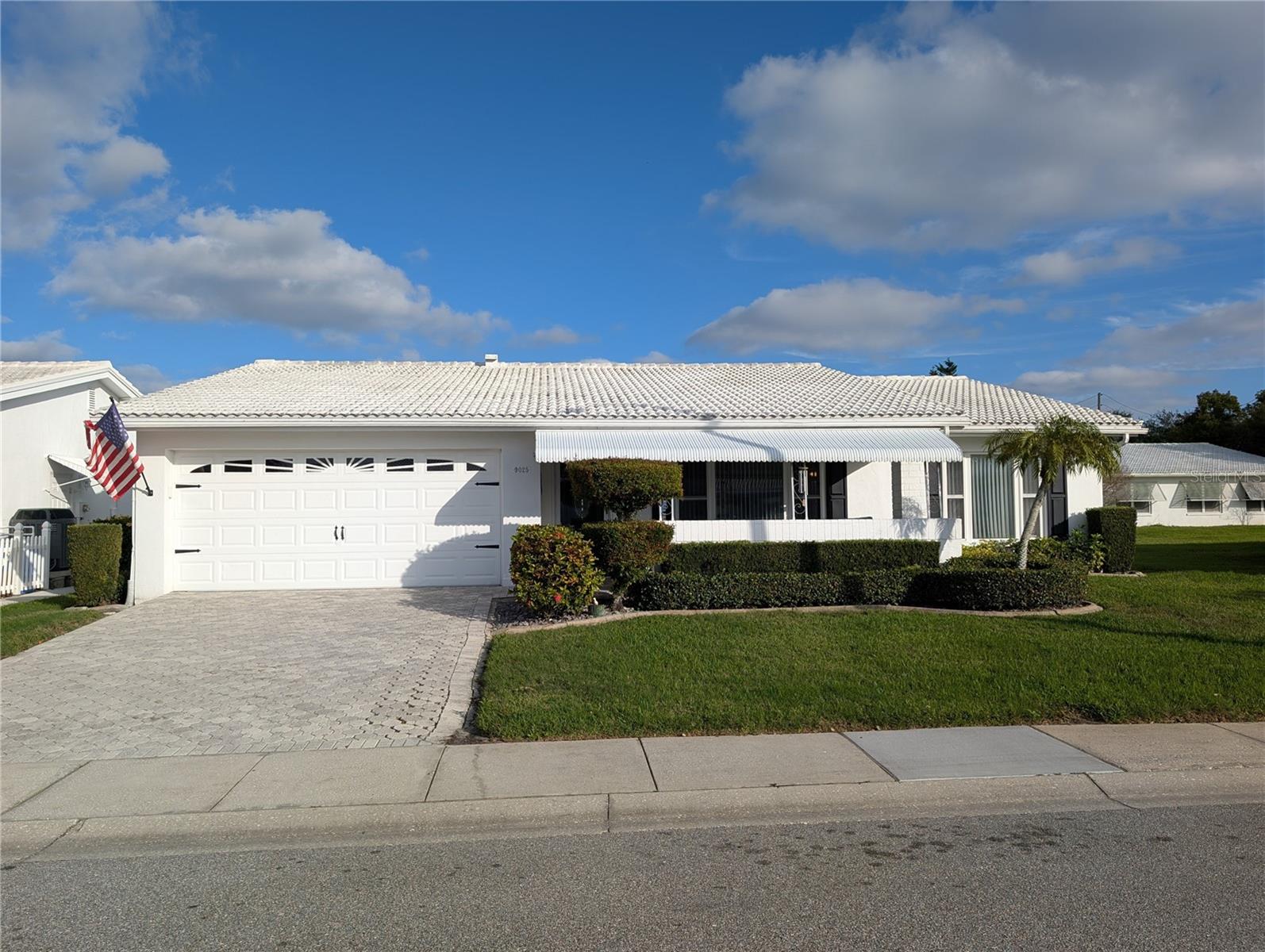 Pride of ownership is evident throughout this well maintained, Gormay floorplan.  This single-family, 2 Bedroom / 2 Bath / 2-car garage block home is located on an oversized lot boasting great curb appeal with a Paver driveway and front porch, shade awning, decorative concrete flower bed curbing, mature landscaping and double-paned windows.  Enjoy a book or a beverage from your private rear patio or enjoy calming views of the neighborhood and cul-de-sac  from the shaded front porch.  The 1,776 sq ft of living space includes spacious rooms with a combination of tile and luxury vinyl (Bedrooms / Bathrooms) flooring and vertical blinds throughout. The updated eat-in Kitchen is designed with extra cabinetry complimented with granite countertops, stainless steel sink and appliances, a passthrough window to the Florida Room and access to the 13x15 Bonus Room which can accommodate a variety of needs - office, den, craft/sewing room or storage.  A set of Maytag Bravos High Efficiency Washer & Dryer are located behind louvered closet doors in the Kitchen along with an additional cabinet and a full set of wall cabinets for more storage capacity.  A linen closet is found in the hallway to the Bedrooms.  The spacious Master Bedroom has an oversized walk-in closet and Ensuite Bathroom with shower. The 11x12 Guest Bedroom has a walk-in closet as well. Both Bathrooms have been updated with new comfort height vanities, faucets, and lighting. The garage measures 19x21 and offers a Chamberlain Belt Drive Wi-Fi Garage Door Opener with external keypad, a pull-down attic ladder, recently painted epoxy floor and a Square D electric panel.  The cement tile roof was replaced in December, 2020. Other updates include a 3-Ton Comfortmaker HVAC (2024), HWH (2018) and an Eaton Electric Panel (2020).   Monthly maintenance of $342.59 includes water/sewer/trash, 1 HD cable box, 1 DVR/DVR recording services, 1 modem and a Wi-Fi router for internet, exterior painting, lawn care, and irrigation with reclaimed water! Mainlands is an active 55+ community offering a variety of activities, clubhouse, heated in-ground pool, shuffleboard courts, nearby shopping, restaurants, banking, Parkside Mall, beaches, sporting & cultural venues, medical care, highways and airports. The community surrounds an 18-hole public golf course and is located adjacent to Freedom Lake Park which has paved walking paths around 2 lakes, an outdoor workout area, playground, picnic pavilions, a dog park, and sailboat racing! 2 pets, 35 lb. max are welcome. Come live this maintenance-free Florida Lifestyle - schedule your showing today!