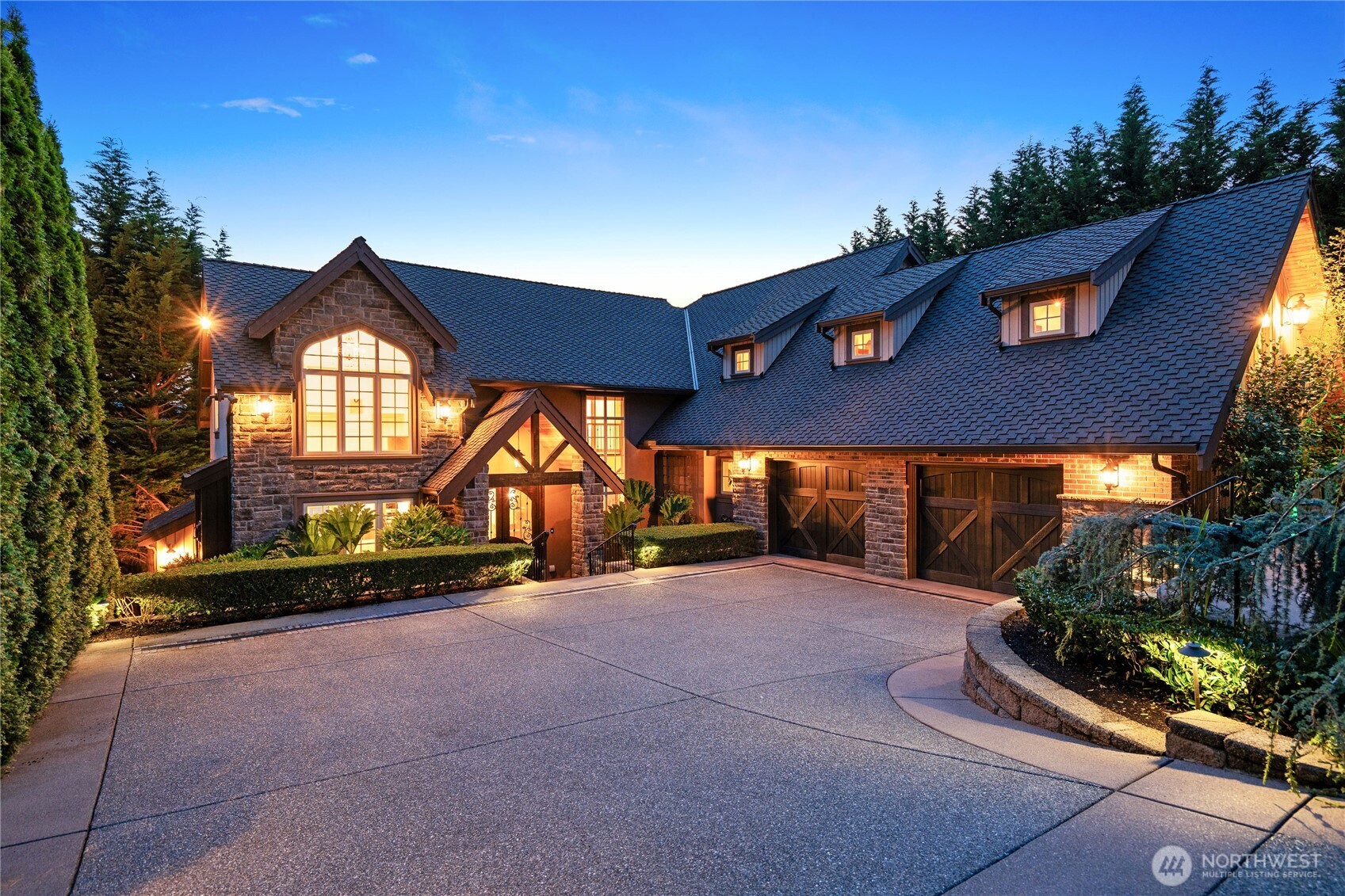 Luxury Lake Sammamish home with gated entry, extensive parking and garages for four vehicles + additional 5th garage for water toys.