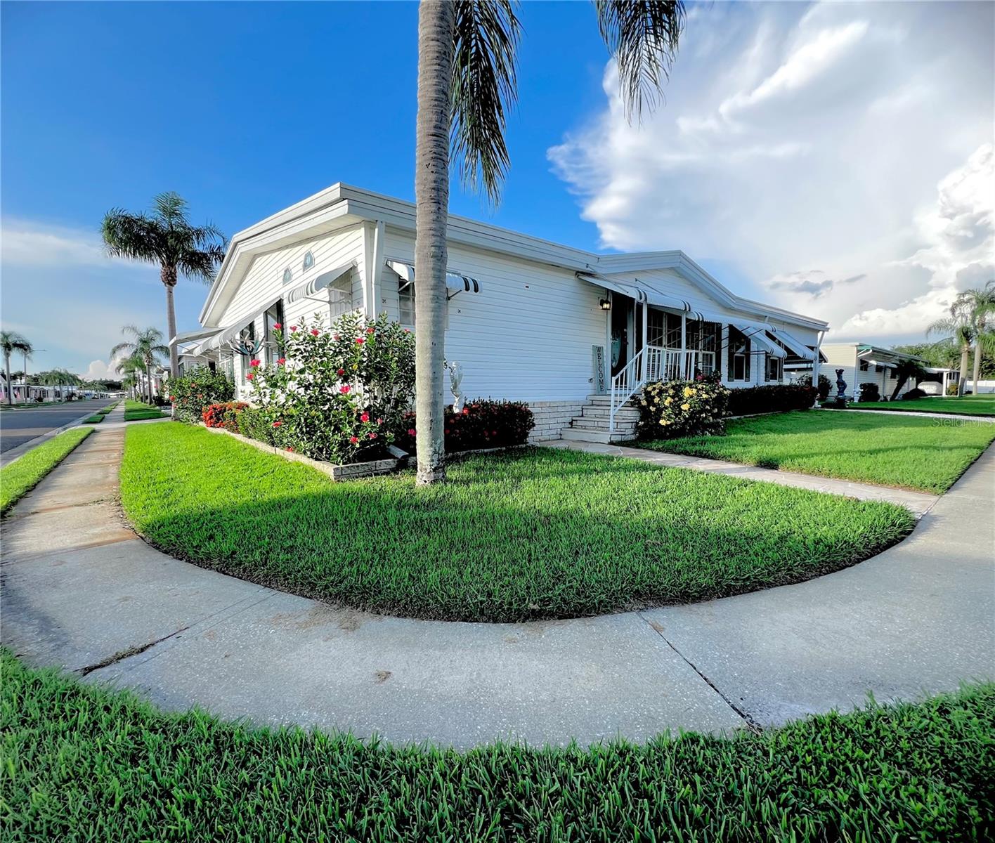 Look no further....THIS ONE IS A MUST SEE!!! UPDATED AND NEWER Exceptional Triple-Wide Home on a Corner Lot in the Pet-Friendly Section is Move-In Ready! APPROVED CONCRETE EXTENSION ON BOTH SIDES OF EXISTING DRIVEWAY TO BE INSTALLED FOR EXTRA PARKING! JUST WAITING ON PERMITS FROM THE CITY OF LARGO!!! Welcome to one of the most spacious and beautifully maintained homes in the highly sought-after 55+ gated community of Fairway Village. This stunning home, built in 2000, sits on a desirable corner lot within the pet section—so bring your furry companion and start living the lifestyle you deserve. This 2-bedroom, 2-bathroom split-bedroom floor plan spans 2,114 square feet of heated and cooled living space—making it one of the largest homes in the community. The open living and dining areas are accentuated by cathedral ceilings and elegant crown molding, ALL NEW Luxury Vinyl Flooring throughout, with tile in the bathrooms and laundry room, offering a sense of spaciousness and comfort. Not to big and not to small.... Enjoy the large side Florida room, located under the carport. With upgraded, side-sliding vinyl windows that can easily be removed to convert the space into a screened-in lanai, it’s perfect for entertaining or relaxing with a cool breeze. Both bedrooms are generously sized, each bathroom and kitchen features natural light from tube skylights, no need for lights to be on in the daytime. The guest bath includes a tub/shower combo, while the primary suite offers a luxurious retreat with an ensuite bathroom featuring a jacuzzi garden tub, separate walk-in shower, double vanities, new lighting, faucette's. The entire home was recently painted and ALL popcorn ceilings were removed with modern textured ceilings throughout in December 2024. The updated kitchen boasting soft-close light cabinetry that contrasts beautifully with countertops—both stylish and functional. For added convenience, the indoor laundry room includes a utility sink, making everyday chores a breeze. An oversized carport provides ample parking for a vehicle and golf cart. The climate-controlled shed (connected to central A/C) offers a rare bonus for storage or hobby use. A METAL ROOF OVER was installed in 2021, offering peace of mind and long-term durability. Resort-Style Living at Its Finest - Fairway Village is not just a neighborhood—it’s a welcoming, vibrant community with resort-quality amenities designed to enrich your lifestyle: Private 9-hole, par-3 golf course with two lakefront fairways and a putting green, Picturesque 5-acre lake for catch-and-release fishing, Two swimming pools and hot tubs for relaxation, Eight covered shuffleboard courts.  A newly opened 19,000+ sq. ft. clubhouse (Jan 2022) featuring: 700-seat auditorium and ballroom, Commercial kitchen & performance stage, Fitness center, library, card & billiard rooms, Multiple conference spaces & cozy sitting areas, Free Wi-Fi throughout. Residents also benefit from a thriving social calendar, with over 50 planned events each year, creating endless opportunities for connection and community. Practical & Affordable is the 2025 Monthly Maintenance Fee of $401 (Includes water, sewer, high-speed internet, 220+ Spectrum TV channels, lawncare, pest control & curbside trash pickup) Optional Golf Membership: $440/year + tax (unlimited play) not open to the public. If you're looking for a spacious, well-appointed home in a warm and welcoming 55+ community that truly feels like family—this is the one to see.