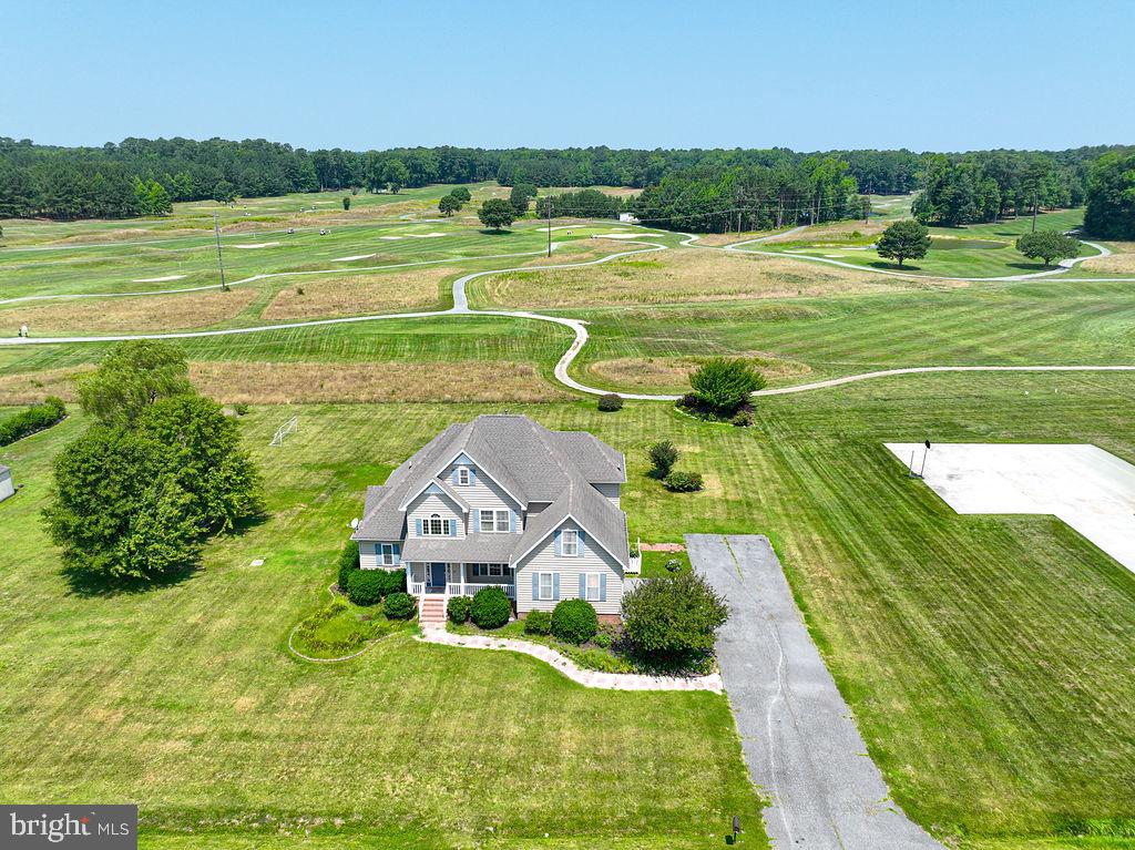 Wow! This custom-built 5-bedroom, 3-full-bath home offers the perfect combination of quality craftsmanship, space, and privacy on 3.45 beautifully maintained acres, just minutes from Ocean Pines, Berlin, and Ocean City. Enjoy peaceful golf course views from your backyard overlooking Ocean Resorts Golf Club while experiencing the tranquility of country living with the convenience of nearby beaches, shopping, dining, and entertainment.Designed for both everyday living and entertaining, the open-concept floor plan features a custom kitchen with hardwood floors that flows seamlessly into the spacious living area. Enjoy casual meals in the eat-in kitchen or host family gatherings in the formal dining room, which also makes an ideal home office or flex space.The first-floor primary suite offers a relaxing retreat with a spacious en-suite bath and walk-in closet. Four additional generously sized bedrooms, three full baths, oversized closets, and abundant storage provide room for family, guests, hobbies, or multigenerational living.Step outside to enjoy the expansive deck overlooking the above-ground pool, where you can relax, entertain, or simply take in the scenic golf course views. A blacktop driveway provides plenty of parking and adds to the home's curb appeal. Sold mostly furnished, this move-in-ready home offers exceptional value, combining custom construction, acreage, privacy, and an unbeatable location close to everything the Eastern Shore has to offer.