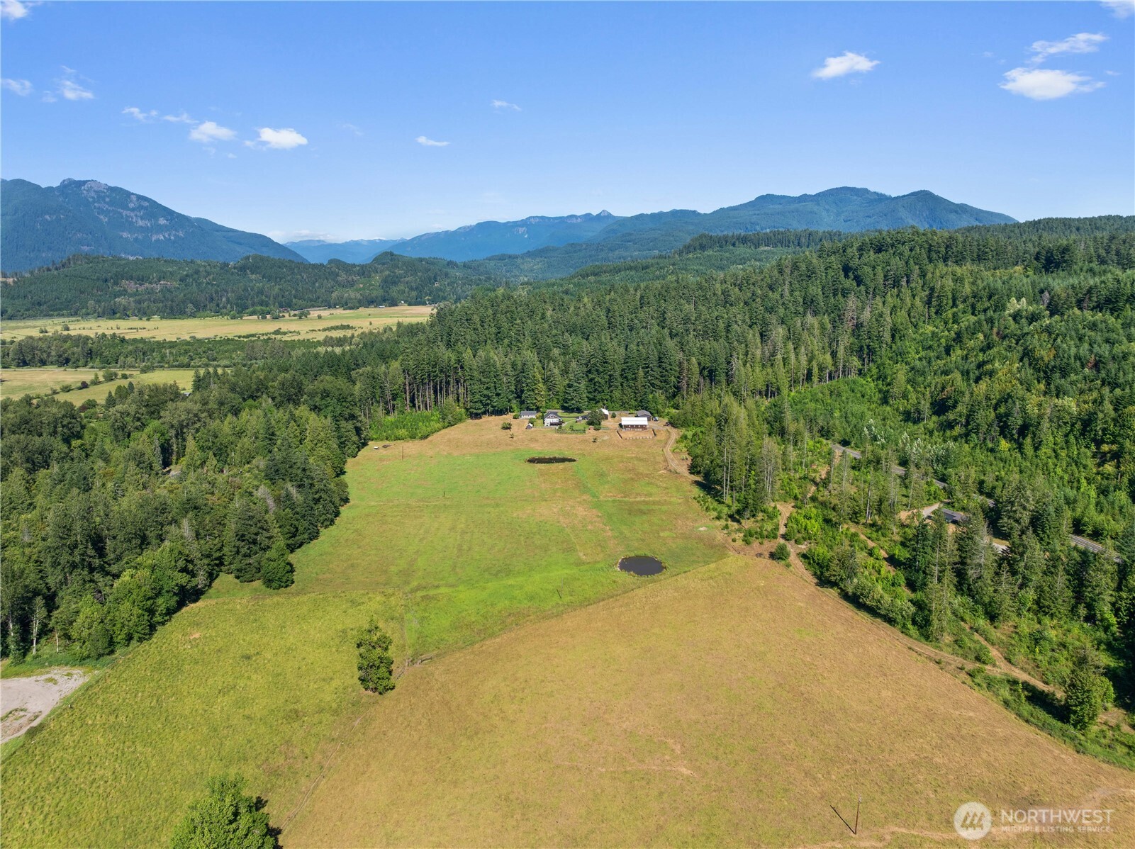 Welcome to Randle Legacy Estate-a rare, shy 80+acre retreat where lifestyle, legacy, & investment potential converge. Comprised of 4 parcels near Packwood, Washington, this extraordinary property features a beautifully restored 3,600 sq.ft. farmhouse, 4 income-producing rental homes, a successful Airbnb apartment, productive pastureland, & established agricultural infrastructure. The farmhouse blends timeless character with modern comfort, featuring a chef's kitchen, expansive dining area, inviting living spaces, & a stunning primary suite, all positioned to capture breathtaking valley, territorial, & mountain views. An expansive deck provides the perfect setting for entertaining, sunset watching, or simply enjoying the peaceful surroundings, while a substantial garden produces abundant flowers & produce throughout the season. Multiple revenue streams—including long-term rentals, short-term vacation lodging, cattle grazing leases, & hay production potential—offer immediate cash flow & long-term investment value. Fenced & cross-fenced pastures, a large barn, equipment shed, detached garage, & impressive shop create endless opportunities for livestock, farming, recreation, or future expansion. Located just moments from Gifford Pinchot National Forest & a short drive to Packwood, this one-of-a-kind estate offers the rare combination of beauty, income, recreation, & country living. Ask your broker for the link to the custom property website for additional info, pics, & maps.