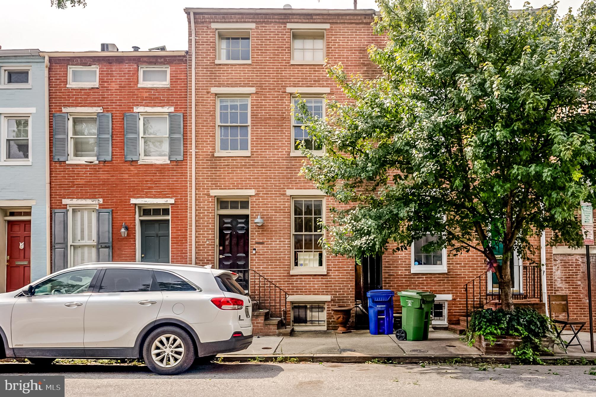 Nestled in the heart of the historic Federal Hill District, this exquisite 1850s townhouse seamlessly blends contemporary elegance with timeless charm. With 1,832 square feet of thoughtfully designed living space, this residence offers a luxurious lifestyle that invites you to unwind and savor every moment. Step inside to discover a warm and inviting atmosphere, accentuated by the rich character of exposed brick walls and the cozy ambiance of a wood-burning fireplace, perfect for those chilly evenings. The spacious layout features four generously sized bedrooms, providing ample room for relaxation and personalization. Two full bathrooms are elegantly appointed, ensuring comfort and convenience for all. The partially finished basement offers a versatile space that can be transformed into a home gym, media room, or additional storage, catering to your unique lifestyle needs. Natural light pours in through the thoughtfully placed windows, creating a bright and airy environment that enhances the home's inviting feel. The contemporary architectural style harmonizes beautifully with the historic surroundings, making this property a true gem in the neighborhood. Enjoy the convenience of on-street parking, allowing for easy access to your home while you explore the vibrant community just outside your door. Living in Federal Hill means embracing a lifestyle rich in culture and convenience. Stroll through charming streets lined with boutique shops, gourmet restaurants, and local parks, all within walking distance. The sense of community here is palpable, offering a welcoming atmosphere that makes you feel right at home. This residence is not just a place to live; it's a sanctuary where luxury meets comfort. Experience the perfect blend of historic charm and modern amenities, all while enjoying the exclusive lifestyle that comes with residing in one of the city's most sought-after neighborhoods. Whether you're entertaining friends or enjoying a quiet evening by the fire, this townhouse is the ideal backdrop for creating lasting memories. Don't miss the opportunity to make this stunning property your new home, where every detail has been curated for your comfort and enjoyment. Embrace the luxury of living in a historic district that offers both tranquility and vibrancy, all in one remarkable package.