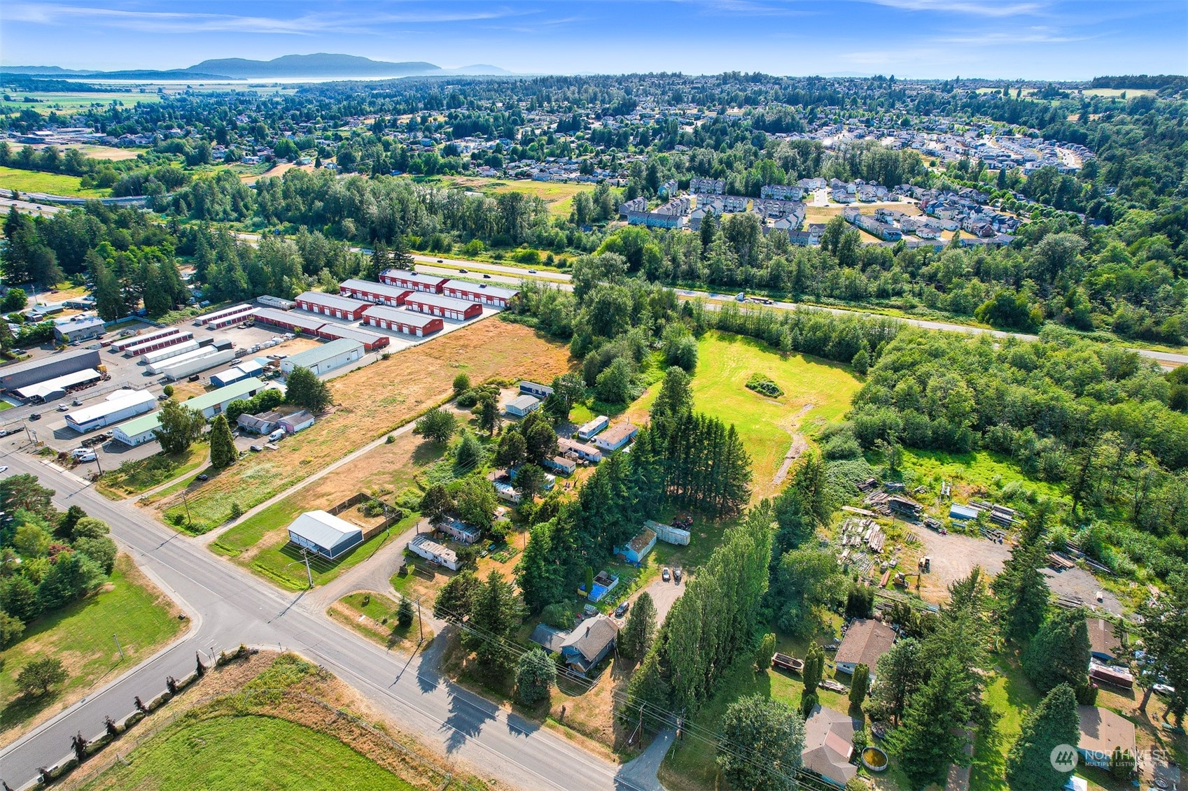 Unlock the potential of this 5.83-acre General Business Commercial (GB) zoned property, featuring prime highway frontage and seamless access to I-5. Strategically positioned near four US/Canadian border crossings and the growing cities of Bellingham, Blaine, and Lynden, this property is well-suited for a wide range of development opportunities, including offices, industrial use, warehousing, or mini-storage. The property also includes a rented house, generating income while you plan its future transformation. With the area’s rising economic activity, this land offers strong potential for long-term growth, making it an attractive investment for developers looking to secure a foothold in a high-traffic, rapidly growing region.