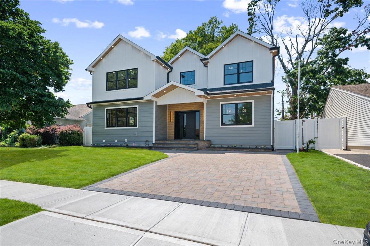 Experience luxury living at its finest in this exceptional new construction, perfectly situated in the heart of Bethpage. Offering over 3,750+ square feet of thoughtfully designed living space, this one-of-a-kind residence features 6 spacious bedrooms, 4 beautifully appointed full bathrooms, and a fully finished legalized basement with a separate outside entrance, providing endless possibilities for extended family, guests, or recreation.From the moment you step through the dramatic two-story grand foyer, you'll appreciate the craftsmanship and attention to detail throughout. The chef-inspired kitchen is the centerpiece of the home, showcasing an impressive 10-foot quartz island, premium GE Monogram appliances, a Liebherr refrigerator, sleek European cabinetry, and a sophisticated dry bar complete with a wine cooler. The luxurious primary suite serves as a private retreat, featuring a spa-inspired bathroom with a rainfall shower, double vanity, walk-in closet, and premium finishes. Smart toilets with integrated bidets, soaring 9-foot ceilings, engineered hardwood flooring, and Anderson 400 Series windows further elevate the home's refined interior.Designed for modern comfort, efficiency, and peace of mind, this home is fully electric and engineered for outstanding energy performance. Featuring blown-in insulation, R-22 high-efficiency thermal barrier siding, and significant roof sun exposure, perfectly suited for future solar installation while helping keep utility costs low. Additional premium features include 2-zone heating and cooling, a 30-year architectural roof, a whole-house water filtration system, and a 4-zone in-ground sprinkler system.The exterior is equally impressive, highlighted by elegant soffit lighting on both the front and rear of the home, a double-wide Cambridge paver driveway offering abundant off-street parking, and exceptional curb appeal. Storage is plentiful with a full finished basement and a full pull-down attic spanning the entire length of the home, ensuring space for everything.Perfectly located within the highly regarded Island Trees School District, this home is just 5 minutes from the Bethpage LIRR station, providing an easy commute to New York City and beyond. You'll also enjoy convenient access to major parkways, shopping, restaurants, cafe's, hospitals, parks, and countless everyday amenities.Luxury, efficiency, location, and quality craftsmanship come together in this truly remarkable home—an opportunity that rarely comes to market. Listed taxes are true current taxes as they have not been assessed yet to its current renovation.