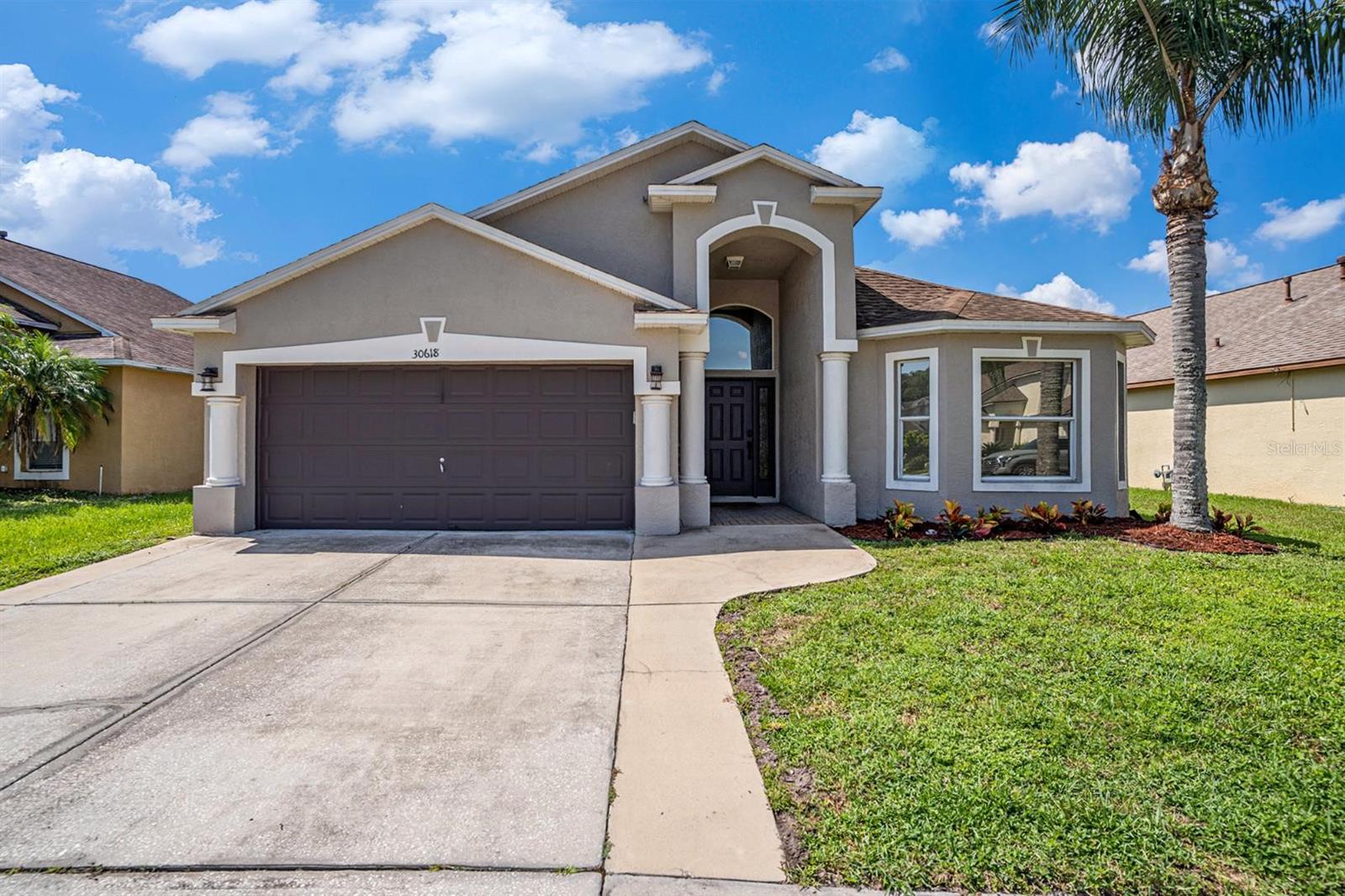 **Home comes with an assumable 3.6% loan on request** Welcome to your forever home in the gated community of Meadow Pointe! With a new roof (2018), HVAC (2023), water heater (2020), appliances (2021), paint (2023) and floors throughout (2021) this home is move in ready! Step inside to a modern kitchen featuring stunning fantasy brown leathered granite countertops and all stainless steel appliances even including a wine frig. The dining room showcases a tongue-and-groove ceiling with LED lighting, while the living room features a stylish pallet accent wall. Additional highlights include a butcher block countertop over the washer and dryer. As you enter into the bedrooms in the rear of the home you will see the newly updated Jack & Jill bathroom that has a waterfall shower head and LED lighting mirror. Step out back is an extended birdcage and 8 person spa and firepit, perfect for relaxing or entertaining! Zoned for some of the top schools in the area and located minutes away from WireGrass mall, Wesley Chapel Outlets, and restaurants, this is a must see!