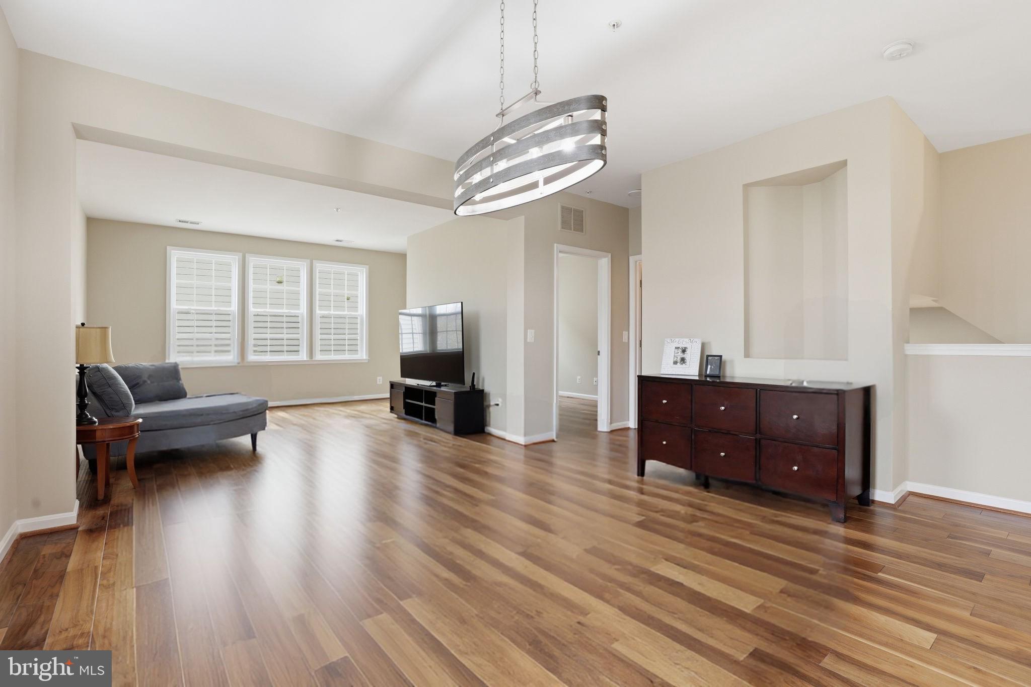 Experience elevated living in this 3 bedroom, 2.5 bathroom,  top-level,  end unit townhome-style condo in Mercer Park, located in the highly sought-after Stone Ridge community. With over 2,600 square feet of light-filled living space, this impeccably maintained home offers the perfect blend of modern upgrades, comfort, and convenience.The open-concept main level features wide-plank flooring, soaring ceilings, and abundant windows on multiple sides. The gourmet kitchen is equipped with granite countertops,  a large island with seating, and a spacious pantry, all flowing seamlessly into the expansive living and dining areas. Step out onto the private balcony—perfect for relaxing or entertaining. A versatile main-level den provides ideal space for a home office, playroom, or flex area.Upstairs, the spacious primary suite includes two walk-in closets and a luxurious en-suite bath with dual vanities, soaking tub, and separate shower. Two additional bedrooms, each with walk-in closets, share a large hall bath with dual sinks. Upper-level laundry adds everyday convenience.Recent updates include fresh paint and carpeting,. Additional features include an attached one-car garage with ample guest parking.The Stone Ridge Community offers unparalleled amenities including 3 swimming pools, tot lots, tennis, basketball, clubhouse, and fitness facility. Convenient access to Stone Ridge Village Center with Harris Teeter grocery, Brew Birds coffee house, Walgreens pharmacy, and more. Don't miss nearby Loudoun County Park n' Ride Lot, Gum Springs Library, Stone Springs Hospital, Dulles South Parks and Rec facility (indoor pool), Dulles International Airport, and Western Loudoun wineries and breweries. Highly sought after Loudoun County public schools. Easy commutes to Dulles/Tysons/DC/Silverline METRO.