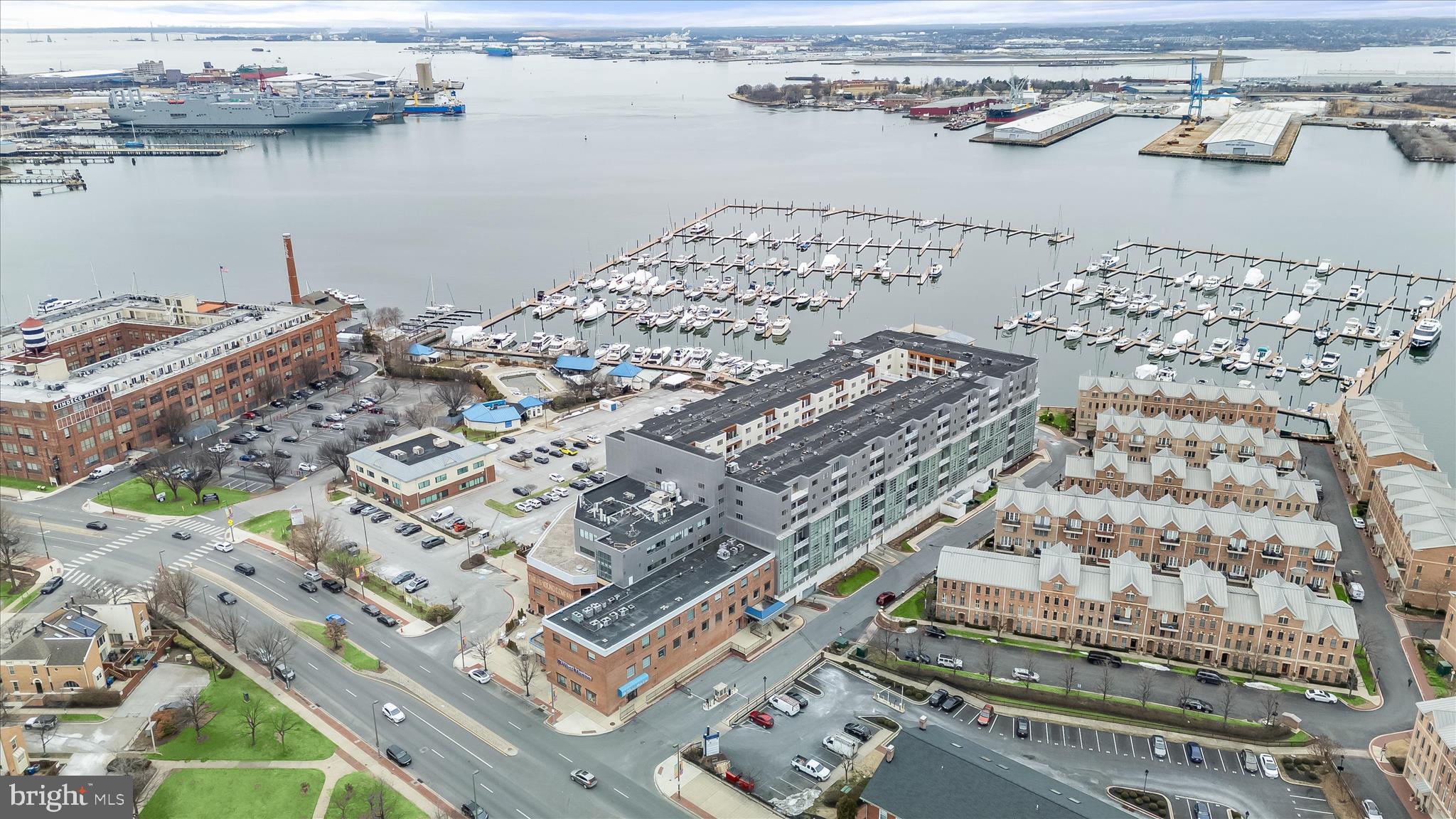 Welcome to this updated and sun-filled two bedroom, two bathroom condo located on the fifth floor in the sought-after waterfront Lighthouse Landing in Canton. Located in a gated community offering 24-hour security with a desk in the lobby, a private garage with one assigned space, elevators, and fitness centers, this building offers excellent convenience and a wonderful opportunity to enjoy a vibrant downtown lifestyle. Step inside where a neutral color palette creates an inviting atmosphere, with elegant crown molding and Brazilian cherry hardwood floors throughout. The open concept layout features sliding glass doors in the living and dining spaces out to a private balcony that boasts views of the harbor and city skyline. The kitchen is equipped with stainless steel appliances, granite counters, 42-inch soft-close cabinets and a pantry. The primary bedroom suite includes a large walk-in closet and a private bathroom with a walk-in shower. Located on the opposite side of the unit is the second bedroom with a walk-in closet, the second bathroom and convenient laundry closet. Enjoy this impressive location with the Lighthouse Point Marina, water taxi, Swim Club, Waterfront Promenade and Canton Waterfront Park just steps from your door. Nearby Canton Crossing shopping center, Merritt Clubs Canton, O’Donnell Square, and a plethora of outstanding restaurants, shopping venues, and entertainment options are just around the corner. Additional updates include a new water heater replaced in 2023.
