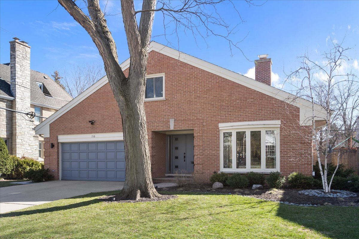 Completely renovated to the studs in 2018, this all-face brick two-story home with bay window and open floor plan blends clean, modern design with exceptional craftsmanship and thoughtful functionality throughout. Set on a beautifully landscaped lot, the home was fully reimagined, not just cosmetically, but structurally, with every major system and finish replaced to create a truly turnkey living experience. The main level is designed for ease and livability. At the heart of the home, the kitchen is both striking and highly functional, featuring an expansive 11 ft quartz island with an integrated workstation, custom cabinetry, premium appliances, and a butler's pantry. Seamless access to the family room, living and dining rooms where a two-sided fireplace adds warmth and architectural interest.  The spacious first-floor primary suite features two large walk-in closets and ensuite with zero threshold shower.  A second full bathroom on the main level adds flexibility.  A conveniently located first-floor laundry/mudroom leads to the attached 2.5-car garage. A striking architectural cable railing stairwell creates an open, light, and airy feel taking you upstairs to a reading nook, bathroom with soaker tub and two generously size bedrooms with vaulted ceilings. Each bedroom has two large closets, the length of the room. Nine Velux skylights flood the upstairs with natural light. Throughout the home, white oak flooring, all new windows and doors, and carefully considered finishes reflect a consistent level of quality. Behind the walls, all systems were replaced-including plumbing, electrical, HVAC, and closed-cell insulation-providing a level of comfort, efficiency, and minimal maintenance. Outside, the fully fenced yard is complemented by thoughtfully designed hardscaping, including UNILOCK permeable bluestone paver ramp and patio, Rochester Thermal bluestone paver walkways, with uplighting and downlighting that enhances both the front approach and backyard. A synthetic DaVinci slate roof with lifetime warranty, attached 2 1/2car garage, accessible, ADA compliant design and extensive upgrades complete this exceptional offering.  This is a home where design and function come together effortlessly, with light-filled spaces, sleek finishes, and a layout made for both easy living and entertaining. Located in the highly desirable Harper, Highcrest & New Trier School Districts with walking distance to Wilmette Schools and Centennial Park with easy access to the Edens.