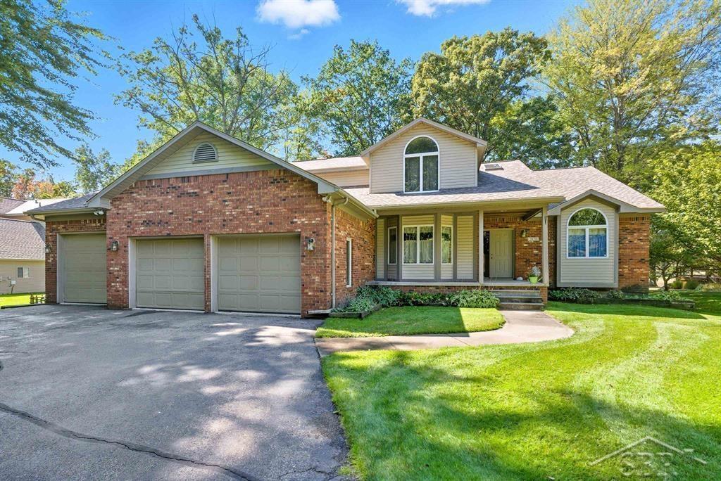 FEATURED ON FOX ROAD! Welcome to your dream home in one of the most desirable locations on Sanford Lake! This gorgeous 2-story Craftsman-style home offers 4 spacious bedrooms, 2.5 bathrooms, and  3,150 square feet of beautifully designed living space all nestled on an extra-large, treed lot with lush green grass and stunning lake views. The main floor is open and inviting, ideal for entertaining or simply relaxing by the large brick fireplace. Step inside and fall in love with the spacious living room featuring large windows and french doors facing the water.  The gourmet kitchen features granite countertops, cabinetry with under-cabinet lighting, a large island and high-end Wolf appliances, including an induction cooktop perfect for the home chef. Enjoy outdoor living at its finest with a large deck and a spacious backyard complete with a firepit area, perfect for keeping warm on cooler nights. Additional highlights include: Heated 3-car garage with hot and cold water hookups, unfinished walk-out basement with 9-foot ceilings, ready for your custom touches, new roof in 2025, and new furnace, water heater and central A/C in 2020. This home offers a rare combination of style, comfort, and unbeatable location. Whether you're enjoying quiet mornings by the lake or hosting summer get-togethers in your expansive yard, this property delivers the lifestyle you've been waiting for. Don't miss this opportunity, schedule your private showing today!