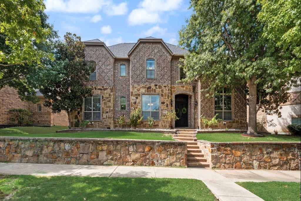 EXCEPTIONAL CUSTOM LUXURY in the heart of Frisco! This stunning one-owner executive residence in desirable Wynngate offers over 4,800 SF of beautifully designed living space with 5 bedrooms, 5 baths, a private study, game room, media room and impressive designer finishes throughout. Step through dramatic IRON double doors into a soaring two-story entry showcasing a statement chandelier with an automated lowering system. Elegant coffered ceilings and gracious living spaces create a sophisticated setting for entertaining.The showpiece kitchen is designed to impress with expansive stone countertops, oversized island seating, WOLF gas cooktop, built-in SUB-ZERO refrigerator, abundant custom cabinetry and exceptional prep and storage space. A wet bar and two dining areas make hosting effortless.The highly desirable floor plan features TWO bedrooms with full baths downstairs, offering flexibility for guests or multigenerational living. Upstairs, three additional bedrooms EACH feature private ensuite baths, complemented by an oversized game room and separate media room complete with screen and projector. Exceptional additional storage includes expanded attic space and a dedicated storage room between the game and media rooms.  Outdoor living is equally impressive with an oversized enclosed covered patio overlooking a spacious backyard with plenty of room to create a resort-style pool and outdoor entertaining space. An upscale electric driveway gate provides additional privacy.The oversized 3-car garage features epoxy flooring and EV charging. Another premium upgrade includes an impact-resistant roof!Luxury appliances, exceptional craftsmanship, extraordinary storage and an incredibly versatile floor plan make this home a standout in Frisco. See Transaction Desk for the extensive list of upgrades. This is one you will want to experience in person!