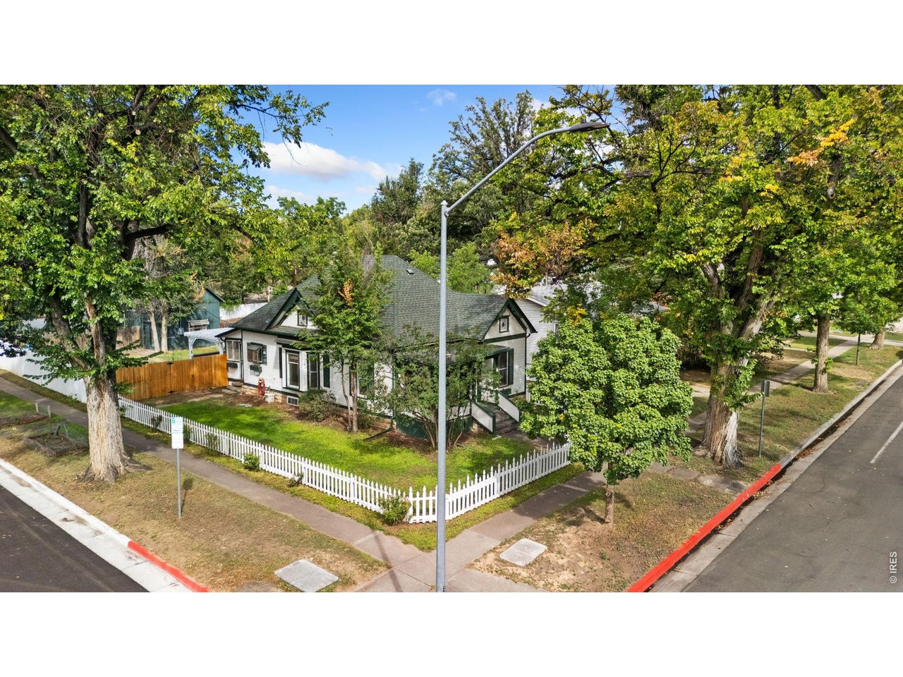 Home has Fort Collins Historic Designation and may qualify for a Fort Collins Landmark Rehabilitation Loan to help make renovations and update this home while keeping it's original features in-tact. Built in 1905 and set in the historic Old Town district, this hidden gem preserves its charm with rich wood floors, classic doors, detailed moulding, a built-in armoire, and vintage windows that reflect its storied past. Well-defined living areas and three bedrooms create a comfortable layout, highlighted by a large south-facing bay window with a cozy built-in window seat. Enjoy exceptional peace of mind with a newer roof and recently updated appliances, including the washer, dryer, dishwasher, range hood, and water heater, all installed within the last 4 years. The expansive yard features a large deck, gazebo, and wood shed. A 624 sqft detached carriage house offers incredible flexibility as a guest house or rental opportunity, complete with a loft bedroom, full bathroom, and a cozy wood-burning stove. Alley access provides excellent off-street parking options. Unbeatable location just two blocks from CSU and the vibrant Flower Trial Gardens, and about a mile to Old Town Square, putting premium dining, shopping, and local favorites within easy reach. No HOA!