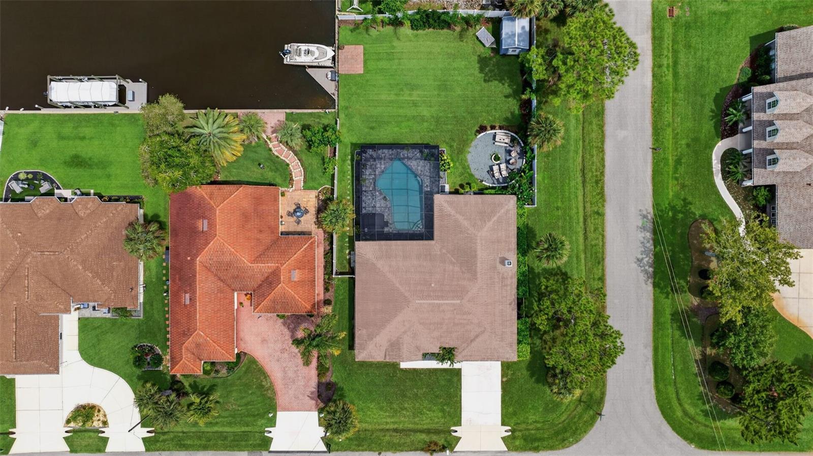 Welcome to the Florida lifestyle you've been dreaming about! Perfectly positioned on a saltwater canal, this spacious 4-bedroom, 2-bath pool home offers more than 2,100 square feet of living space on an oversized corner lot, with the water right in your backyard. Whether you're spending the day out on the water, relaxing poolside or entertaining friends under the covered lanai, this home was made for enjoying everything Florida living has to offer. Fresh exterior paint gives the home a clean, updated look, while inside, new flooring adds to the fresh feel throughout. The spacious kitchen features abundant cabinetry, solid-surface countertops, stainless steel appliances and a large breakfast bar with plenty of room to gather. Multiple living spaces give everyone room to spread out, including separate living and dining areas plus a generous family room with a fireplace. The primary suite feels like its own retreat with sliding glass doors leading directly to the covered lanai and pool, along with an ensuite bath featuring dual vanities, a walk-in shower and separate jetted tub. Outside is where this home really shines! Take a dip in the large screened pool, unwind overlooking the canal or simply enjoy having your own waterfront escape right at home. When you're ready to venture out, you're just minutes from the Atlantic Ocean, restaurants, shopping, walking and biking trails and so much more. Roof and A/C replaced in 2018. Pool, waterfront, plenty of space and your own piece of the Florida lifestyle...this one is ready to enjoy!