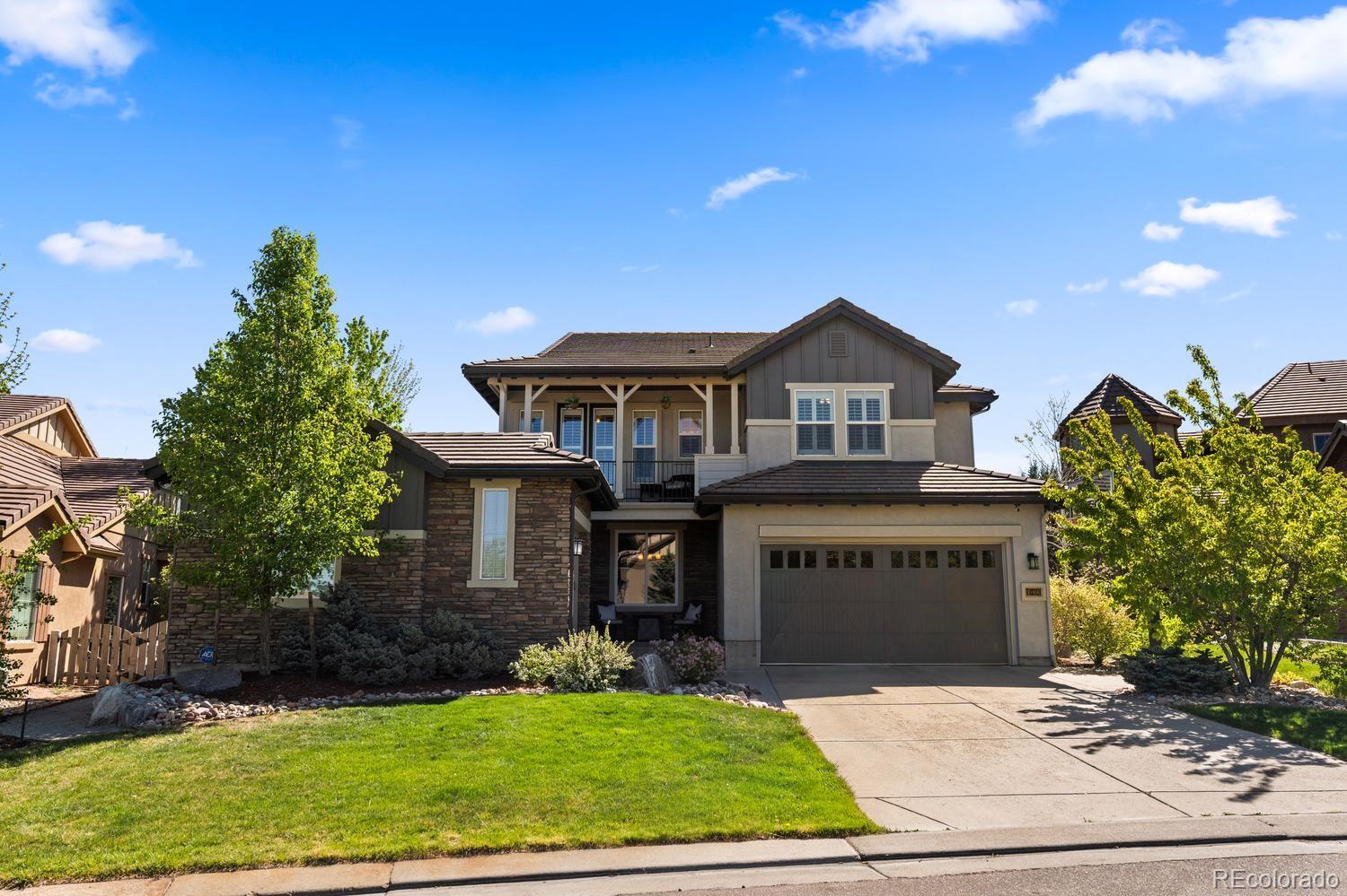 Set on a quiet cul-de-sac backing to open space, this beautifully upgraded home is the ultimate family retreat, warm, inviting, and designed for effortless Colorado living. Refinished hickory floors set a polished tone, while rich wood accents, custom beams, soaring ceilings, and a dramatic two-story brick wall create depth and architectural character. A freshly painted exterior enhances the home’s crisp presence, while mountain views from the front add to its appeal. The kitchen is designed for the way people live and gather, offering generous prep space, a gas range, double ovens, two dishwashers, a warming drawer, walk-in pantry, and a butler’s pantry that keeps entertaining seamless. The dining room feels elevated yet inviting with a wood coffered ceiling and beamed trim. The main living spaces flow outdoors to a wraparound patio with an outdoor kitchen, built-in grill, serene water feature and custom lighting—perfect for evenings that linger long after sunset. The family room opens to the kitchen and features custom beamed ceilings, automated window treatments and a gas fireplace with brick surround. The cozy den with fireplace and lower level pocket office offer flexible spaces for those working from home. Designed to live well through every stage of life, the floor plan includes a main-level guest suite with en-suite bath and generously sized upper-level bedrooms each with plantation shutters and walk-in closets. The serene primary retreat offers a spa-like bath with dual vanities, walk in shower with dual shower heads, & two walk-in closets. The finished lower level with double sided fireplace and wet bar is ideal for movie nights and casual gatherings. Dual water heaters, a Halo water system and a humidifier add comfort behind the scenes. Relax out front, take in the mountain views, and watch kids play in a peaceful setting. Refined, private, and surrounded by nature. #bestofbackcountry  Professional photos by Monday. Call Sarah @303-667-0879 w/ questions.