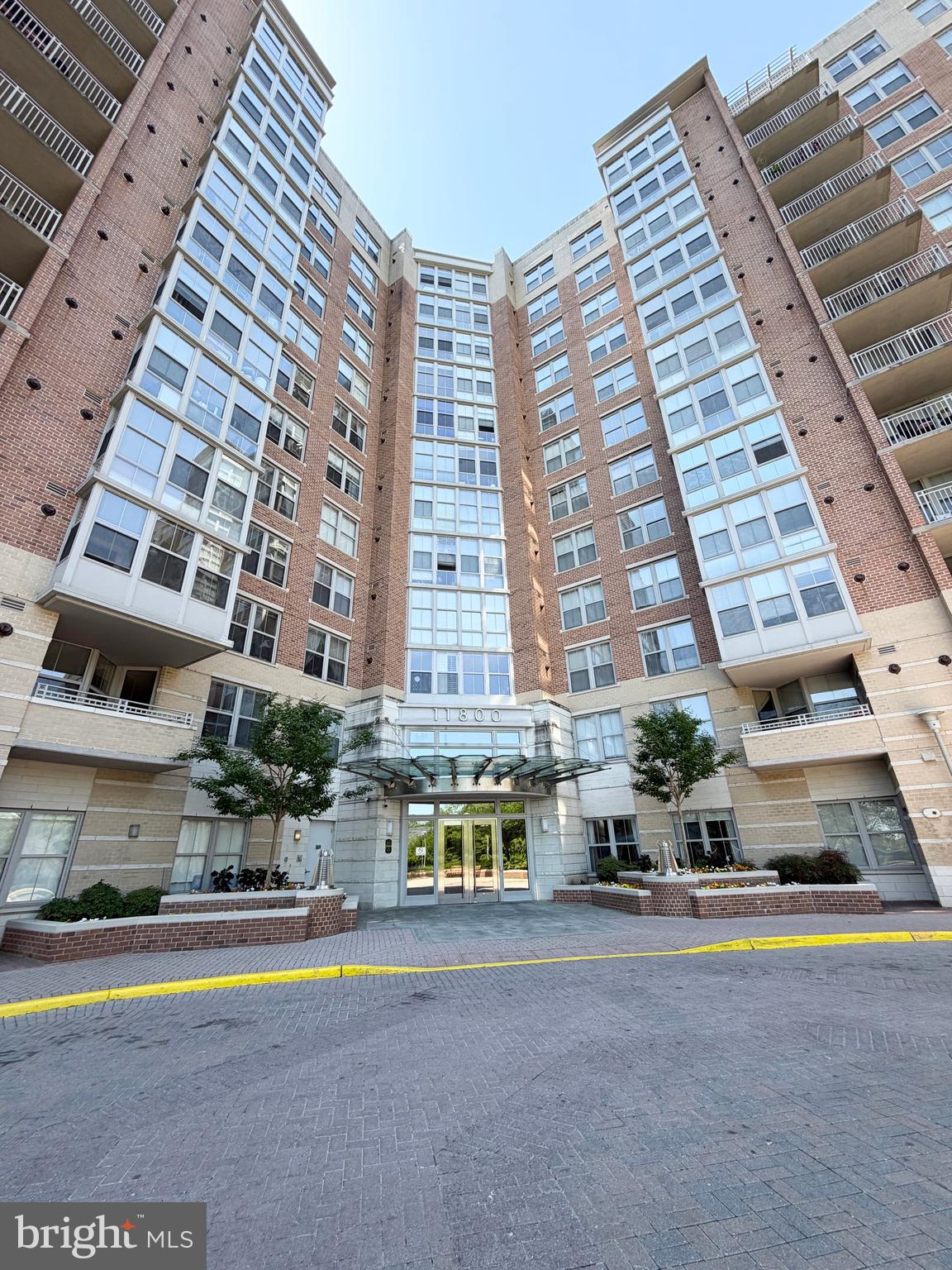 Rarely available corner-unit condo offering 1,177 square feet of beautifully updated living space in one of Reston's premier luxury communities. Filled with natural light, this spacious 2-bedroom, 2-bath residence features an open floor plan, real hardwood floors throughout the main living areas, and new carpet in both bedrooms. The generous primary suite includes a private bath and ample closet space, while a new hot water heater (2023) provides added peace of mind. Two conveniently located, assigned garage parking spaces convey.Enjoy resort-style amenities including 24-hour concierge, rooftop pool, grilling terrace, fitness center, sauna, theater room, club room, business center, billiards room, coffee bar, and extra storage. Ideally situated just steps from Reston Town Center, you'll have premier shopping, dining, entertainment, concerts, ice skating, WO&D Trail access and community events right outside your door. Commuters will appreciate easy access to the Silver Line Metro, Route 7, the Dulles Toll Road, & Fairfax County Parkway.Offering the perfect blend of luxury, convenience, and lifestyle, this move-in-ready corner residence is a rare opportunity to enjoy the very best of Reston living.