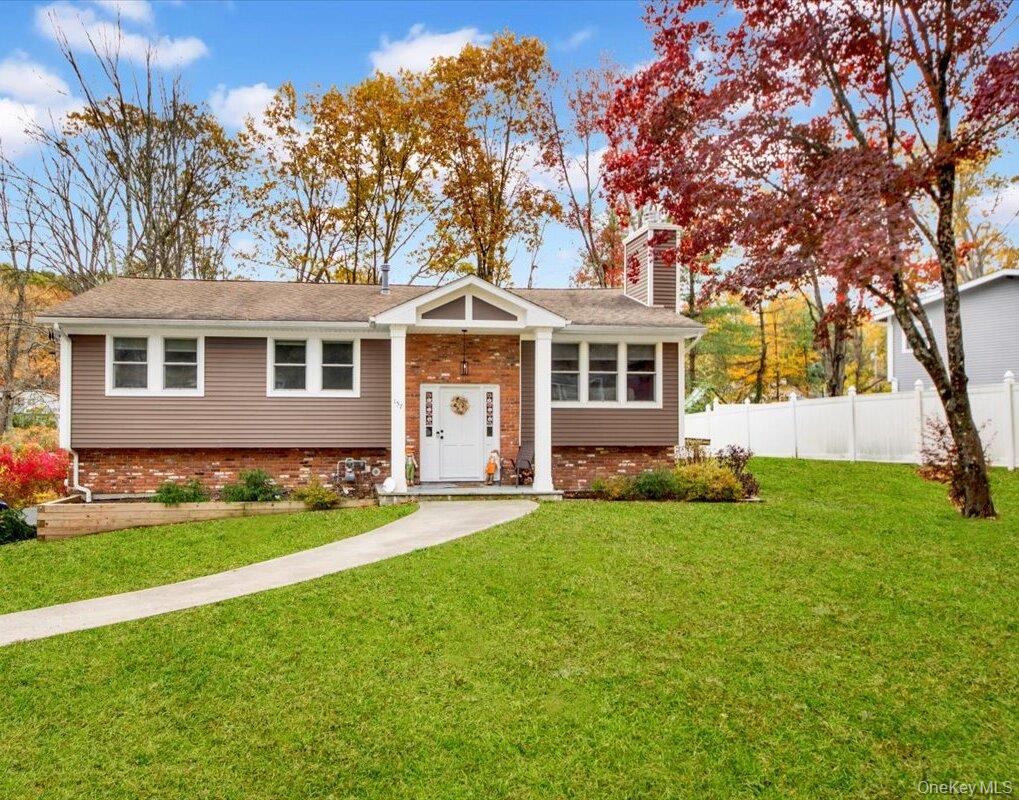 Welcome to 157 Phyllis Court — a completely renovated sprawling hi-ranch tucked away on a private cul-de-sac in Yorktown Heights, within the award-winning Lakeland School District! Rebuilt in 2022, this home is truly turnkey. Step inside to a bright open-concept living area with vaulted ceilings, a wood-burning fireplace, and gleaming oak floors. The chef’s kitchen features a large island, quartz countertops, and flows seamlessly to a composite deck overlooking the private, tree-lined backyard — perfect for entertaining. The main level includes 3 spacious Bedrooms, including a primary suite with a private full bath, plus an additional hall bathroom. The lower level offers exceptional flexibility, featuring a private entrance, bedroom, full bath, laundry area, and a large family or recreation room that opens to a covered patio—perfect for guests, extended family, or a home office setup. Energy-efficient upgrades include spray foam insulation, high-efficiency Andersen windows, and LED lighting throughout. Additional highlights include a two-car garage, spacious attic with pull-down stairs, and a low-maintenance exterior. Beautifully renovated, energy-efficient, and move-in ready, 157 Phyllis Court delivers the perfect combination of modern comfort and relaxed suburban living!
