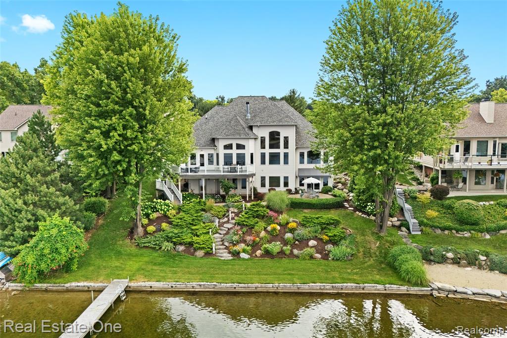 Absolutely stunning custom-built lakefront home with 101 feet of frontage on beautiful Pine Lake, set among meticulously landscaped grounds. Offering over 4,600 square feet of refined living space, this 4-bedroom, 4-bath residence combines luxury, comfort, and breathtaking views.The gourmet kitchen features custom cherry cabinetry, wood flooring, granite island, tumbled stone backsplash, and a dual-facing fireplace, flowing seamlessly into the great room where soaring ceilings and a dramatic wall of windows frame the lake. The primary suite is a true retreat, complete with panoramic views, trey ceilings, and a beautifully appointed bath.A newly remodeled finished lower level provides additional space for entertaining, while the sunroom and expansive new Trex deck with glass-panel railings offer the perfect setting to enjoy both sunrises and sunsets.Recent updates include a full-house generator, new furnace and air conditioner, new dock, and fortified break-wall. Pine Lake is ideal for fishing, kayaking, swimming, and relaxing pontoon evenings — exceptional lake living at its finest.