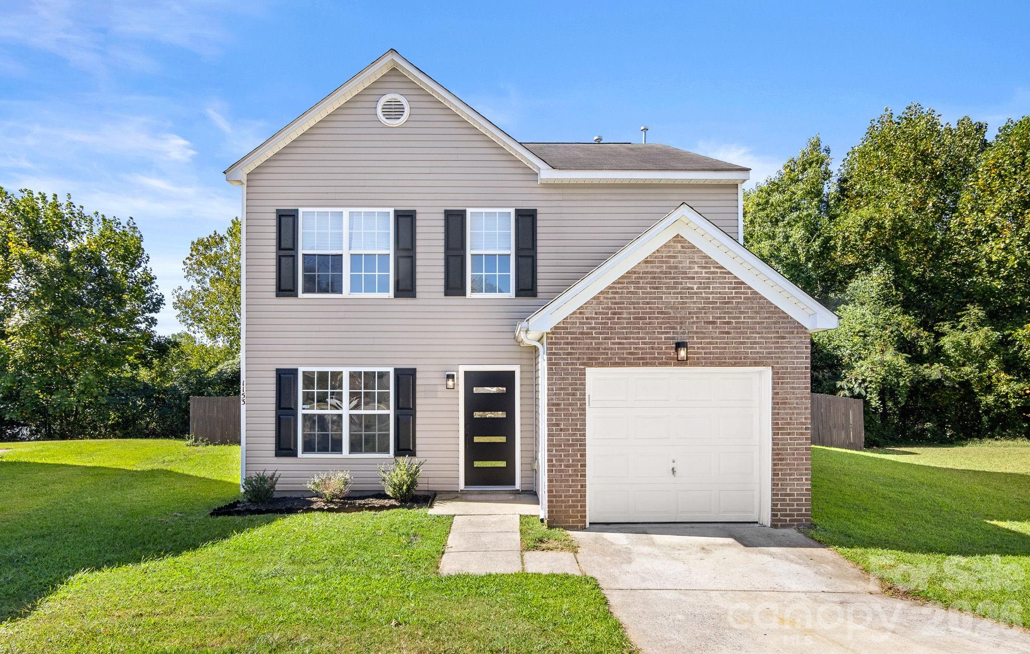 Come see this beautifully renovated home tucked away on a cul-de-sac in Northwest Charlotte! Conveniently accessible to I-485 and I-85 makes it easy to get to Charlotte Douglas Airport, Uptown and destinations throughout the city. Once inside the beautiful brand new front door - the main level features new LVP flooring, fresh paint AND a dramatic two-story great room with a custom floor-to-ceiling fireplace feature wall and electric fireplace. The refreshed kitchen offers new cabinetry, waterfall quartz countertops, quartz backsplash and stainless appliances. With three full bathrooms, the updates continue throughout with modern finishes, quartz countertops, floating vanities and LED backlit mirrors. Upstairs, the bright and airy primary suite features a cathedral ceiling, custom accent wall and spacious walk-in closet. The fully renovated primary bath features a freestanding soaking tub, oversized tiled shower with frameless glass and a modern floating vanity. Additional updates include new carpet, interior light fixtures, new furnace, new gas water heater, modern front door and exterior lighting. Outside, enjoy a fenced backyard, attached garage, driveway and built-in outdoor storage. Move-in ready with the updates already done!