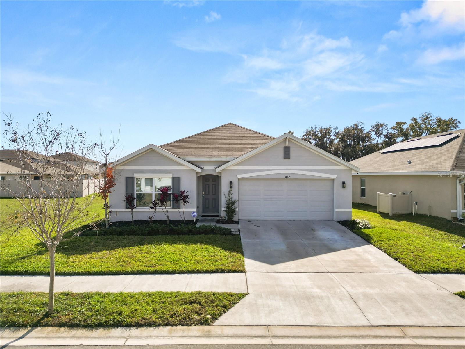 One or more photo(s) has been virtually staged. Welcome home to this 2022-built 4 bedroom, 2 bathroom home in the highly sought-after North Park Isle community of Plant City. While new construction nearby may still be underway, this home stands out with valuable upgrades already completed—including a fully fenced backyard, screened-in lanai, and air-conditioned garage.Inside, the home has been gently lived in and thoughtfully maintained. The open-concept layout is ideal for both everyday living and entertaining, featuring granite kitchen countertops, stainless steel appliances, and a modern, neutral design that feels fresh and move-in ready. The kitchen flows seamlessly into the living and dining areas, creating a bright and welcoming space.Step outside to enjoy Florida living at its best with the screened lanai overlooking the private, fully fenced yard—perfect for pets, play, or relaxing evenings without the bugs. The A/C-equipped garage adds flexibility and comfort, ideal for a home gym, workshop, storage, or temperature-controlled parking.North Park Isle offers community amenities including a clubhouse, pool, playground, and recreational areas, all while being conveniently located with easy access to I-4 for commuting to Tampa, Lakeland, or Orlando.Why wait on a builder timeline or pay extra for upgrades? This home offers the benefits of newer construction without the wait, plus features buyers are actively searching for but rarely find already done.