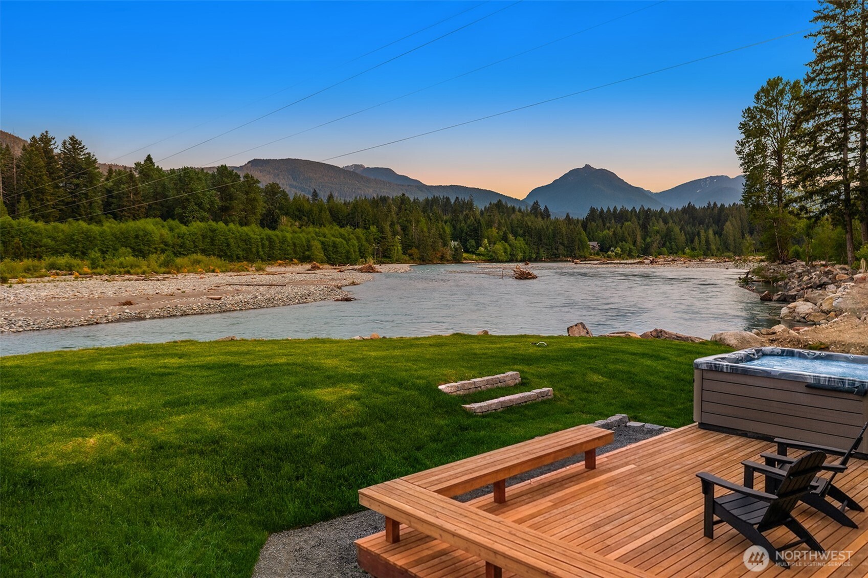 Picture-perfect cabin with stunning dynamic Cowlitz River views from nearly every room and tremendous STR potential. Envision the viral marketing opportunity with influencer posts showcasing guests enjoying the hot tub with 200-degree views of the river. This fully remodeled cabin features LVP throughout, slab concrete countertops, and three ductless mini-splits for guest comfort regardless of the season. After a day on the slopes at White Pass or hiking Mt. Rainier National Park -- both 25 mins away -- enjoy relaxing by the riverfront fire pit, then cozy up on the sofa for a movie with the wood burning stove perfectly warming the cabin. The newly re-sodded yard is fully fenced, ideal for welcoming guests with pets. The brand new massive shoreline armoring created an ideal elevated riverfront relaxation vista. And, the newly rebuilt and restained deck is picture perfect for enjoying your mountain retreat from sunrise to sunset. As a member of the High Valley community, you'll have access to the golf course, pool, and clubhouse. Sold almost fully furnished for either a turnkey STR investment, your private riverfront cabin, or both -- just in time for ski season!
