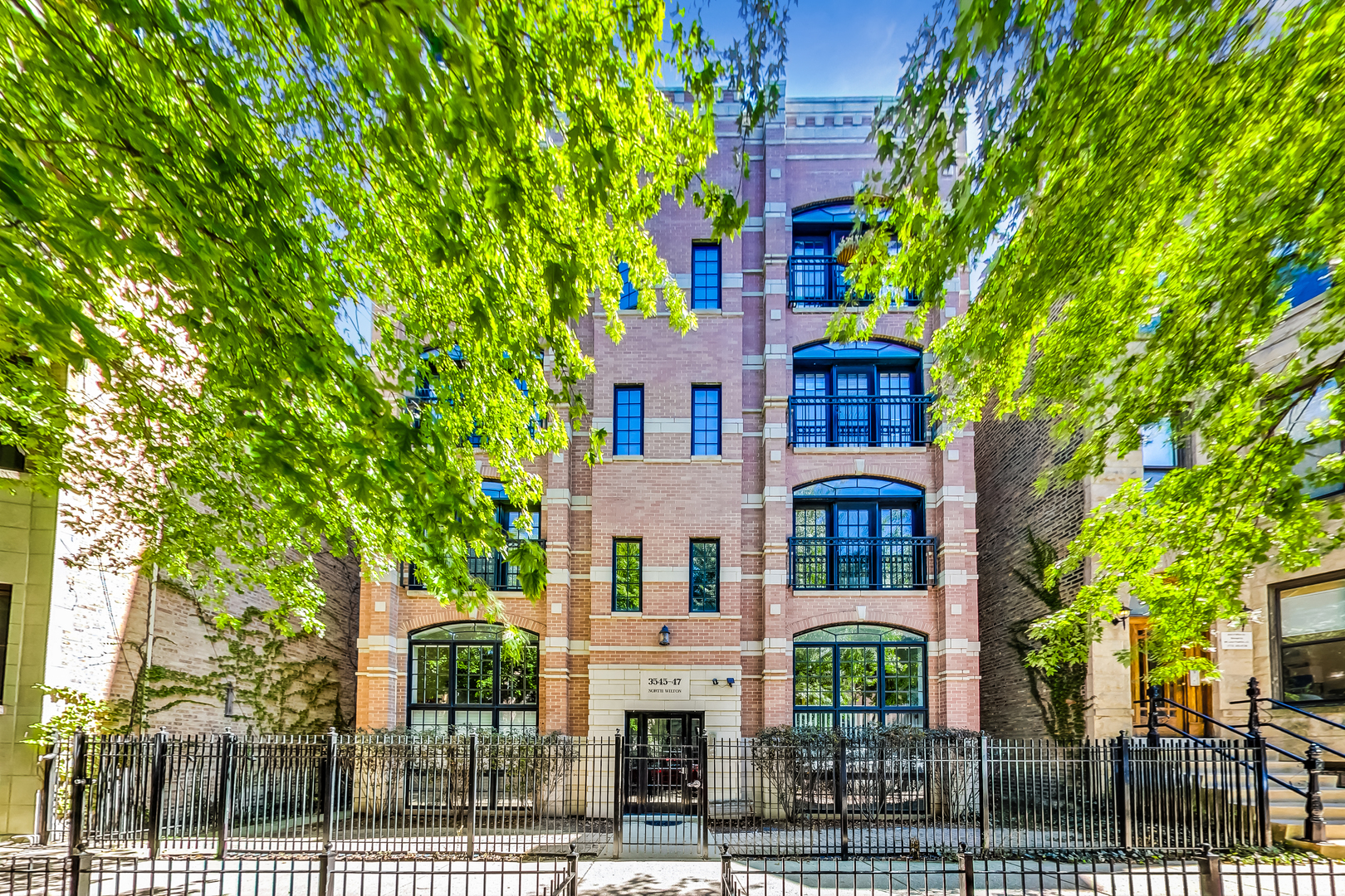 Penthouse living with your own private rooftop deck overlooking Wrigley Field in a premier all brick building built by the Gold Standard Builder Heneghan Homes. Situated in the middle of everything on a tree-lined street this 1645 square foot 2bed/2bath home has exquisite finishes and impeccable details - incredible room sizes, extensive moldings and millwork, tray ceilings, the entire home is wired for surround sound, a wood-burning fireplace, 9 foot ceilings, Brazilian cherry floors  and solid wood doors. The great room is exactly that, great. There is plenty of room to accommodate living and dining room furniture. The chef's kitchen has a Subzero refrigerator, Viking range, Bosch dishwasher, cherry cabinets and thick honed granite countertops. The room sized 13'x11' primary bath w/heated floors has dual vanities, jacuzzi tub, a separate toilet room and the shower stall has steam. The 16'x15' generous primary ensuite has an 11'x5' balcony, 9'x7' organized, built out walk-in closet and accent lightening in the customized tray ceiling. Good sized 2nd bedroom w/tray ceilings and built out closets. Take the interior staircase up to your completely private 1300+ square foot rooftop deck spanning the entire length of the building. It is awaiting your vision of outdoor luxury living. One attached, heated garage parking spot is included in the price with a heated driveway and a private storage room right outside the garage. Although you are just around the corner from the Addison CTA Red Line station and Wrigley Field it feels like you are miles away because of the caliber of this building. It is top notch quality inside and out. All of this in a convenient Wrigleyville, East Lakeview location steps from everything.