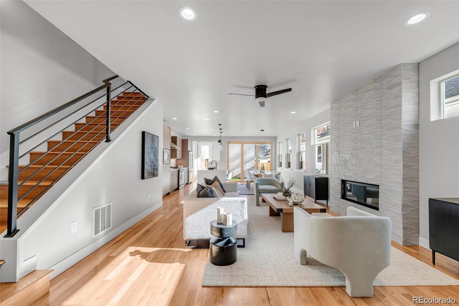 Modern Luxury Duplex 3 Bed / 4 Bath + Office + 3rd Level Loft + South facing Rooftop Deck... in Denver's beloved Sunnyside Neighborhood.  This is the coveted South End Unit drenched w/sunny natural light and the perfect combination of modern luxury + neighborhood charm. Quiet Street, Open-concept main level, REAL Oak hardwood floors, large windows, + high ceilings. The chef's kitchen is a dream w/ stainless steel appliances, waterfall quartz countertops, a center island, + the dining area opens up to the backyard through a bifold glass wall that brings the outdoors in year-round. The living area features a gorgeous fireplace w/a ceiling-high ceramic tile hearth, adding warmth + sophistication to the space. At the front of the house, is a dedicated office space, perfect for remote work, study, or creative pursuits. Retreat to the spacious master suite featuring a walk-in closet + a luxurious en-suite bathroom with dual vanities and a walk-in wet room with a shower and soaking tubs. Exquisite design choices for finishes/tile, you will feel the difference in Quality.   Two more bedrooms offer plenty of space for family members or guests, each with easy access to a shared bathroom. The Laundry Room is conveniently located on this level. The top floor also offers a flexible space that can serve as a family room, entertainment area, or even a 4th bedroom with a 4th Bathroom! Sliding glass doors lead to an upper-level deck where you can enjoy the seasons with a magnificent mature tree and gas/water hookups. The two-car garage keeps your vehicles clean + secure while the additional loft provides extra storage space for your tools and toys. High Efficiency HVAC, Central A/C, Tankless Hot water heater, + dedicated heat/cool mini-split for the 3rd level loft. Don't miss the opportunity to make this stunning duplex your new home in one of Denver's most desirable neighborhoods. You will feel the difference in quality.