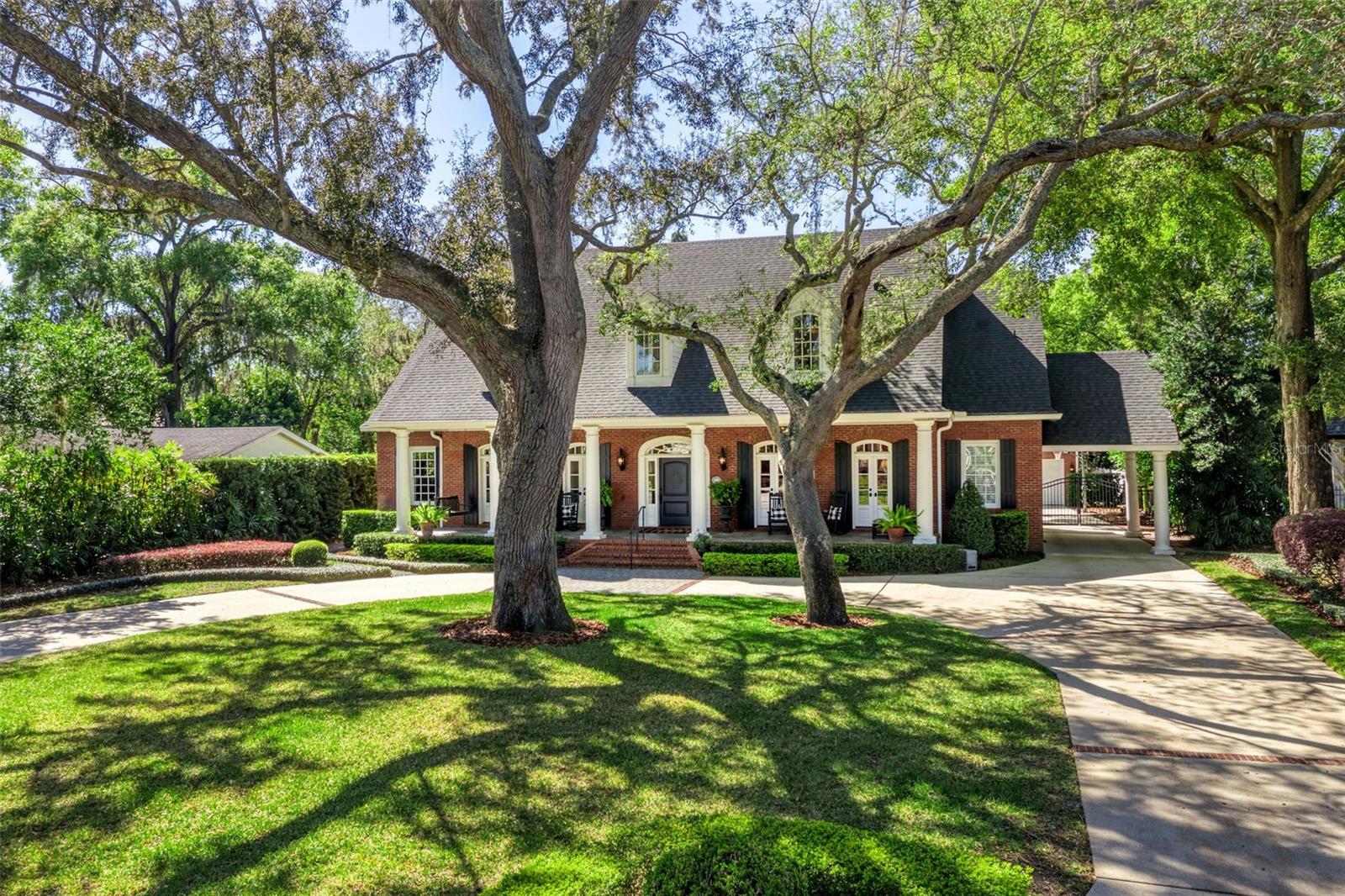 Under contract-accepting backup offers. Set on a sprawling half-acre, surrounded by meticulously manicured landscaping, this custom-built traditional estate exemplifies refined luxury, modern convenience, and an unparalleled lifestyle.
The red brick façade, covered porches with glass doors, and gated side porte-cochere set a timeless tone, while two-story fluted columns add stately elegance. 
Inside, classic architectural details merge with modern design, highlighted by two-story coffered ceilings, intricate millwork, and expansive windows and French doors that flood the home with natural light.
Thoughtfully designed for both entertaining and everyday living, the gourmet kitchen includes a 6-burner Viking gas cooktop, double dishwashers and sinks, a paneled refrigerator and separate full-sized freezer, a walk-in pantry, and an oversized island with breakfast bar seating.
The first floor features a private primary retreat, two powder rooms, a workstation/mudroom accessible off the porte-cochere, and one of two laundry rooms.
Upstairs offers three spacious bedroom suites with walk-in closets, a versatile bonus room, and a second laundry room.
Embrace the Florida lifestyle from a two-story covered brick patio with a built-in gas grill, overlooking the private, fenced-in backyard oasis and breathtaking saltwater pool and heated spa, all elevated by a three-tier fountain and fire pit area, and wrapped in lush landscaping; this outdoor space is truly magical and not easily replicated in Winter Park!
A circular driveway provides ample parking, while a gated side drive leads to an oversized, detached three-car garage with a bonus room above—ideal for a gym or studio.
This particularly grand, wide street in the City of Winter Park is something truly special. Ideally located near Baldwin Park, Corrine Drive, and Park Avenue, and zoned for highly regarded Audubon K-8, this estate is more than a home—it’s a statement in timeless elegance. *Ask for a list of improvements, the floorplan and click on the virtual tour!
