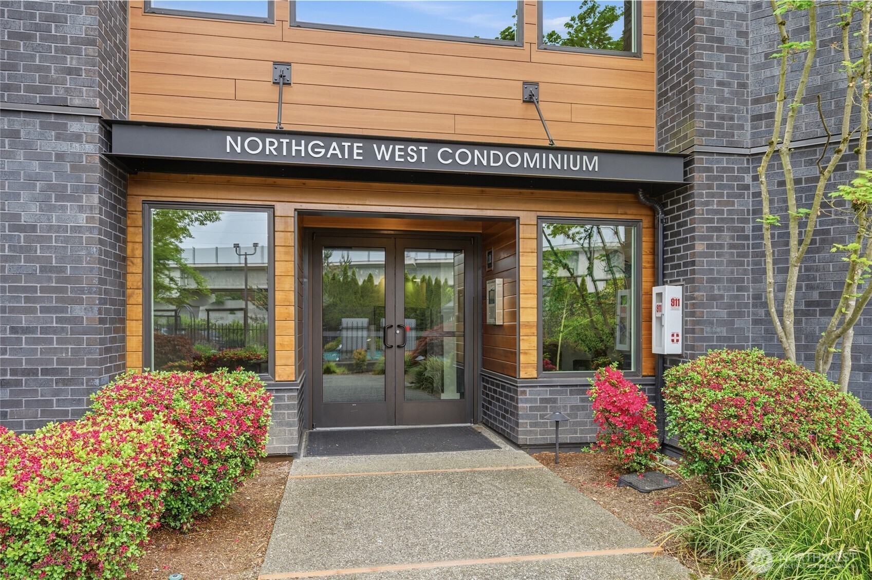 Beautifully remodeled top-floor 2-bedroom, 1.75-bath condominium in the sought-after Northgate West community. This spacious and thoughtfully updated home combines modern finishes, comfort, and convenience in one of Northgate’s most desirable locations. The interior features updated kitchen and bathrooms, a cozy fireplace, private balcony, air conditioning, in-unit washer and dryer, and abundant storage throughout. The spacious primary suite includes an updated ensuite bath, while the second bedroom offers excellent flexibility for guests, hobbies, or a home office. A private storage unit conveniently located on the same floor adds even more functionality.The oversized secured garage with automated entry provides exceptional convenience. Park in the garage and access a nearby secured entrance with elevator access that brings you directly to the unit floor. The unit is also ideally positioned very close to the north elevator for effortless daily access.Residents enjoy community amenities including an outdoor pool, spa, barbecue area, and ample guest parking. The complex underwent extensive exterior remodeling and received a new roof in 2023, offering added value and peace of mind.Ideally located just one block from the light rail and moments from shopping, dining, medical facilities, bus lines, North Seattle College, and major commuter routes.