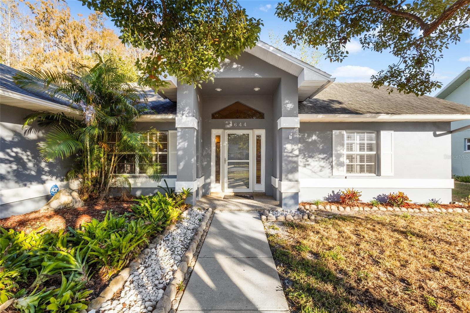 This beautifully updated three-bedroom, two-and-a-half-bath, two-car garage home is perfectly situated on a conservation lot with a peaceful pond view in the highly desirable Park Lake Estates community. Featuring an open and efficient split-bedroom floor plan, the home offers both privacy and functionality. Upon entering through the foyer, you are welcomed into a spacious living room that flows seamlessly into the dining area, kitchen, and enclosed sunroom, creating an ideal layout for both daily living and entertaining.The renovated kitchen is a standout, showcasing stainless steel appliances, granite countertops, Marazzi porcelain backsplash, solid wood cabinetry, and recessed lighting. The oversized primary suite offers exceptional comfort with two separate walk-in closets and a rare dual-bathroom configuration that provides private facilities for each occupant. Two additional bedrooms are located on the opposite side of the home, adjacent to the guest bath and an indoor laundry room, enhancing the privacy of the floor plan.This home has been extensively refreshed with new interior and exterior paint, new toilets, new carpet in select rooms, professional carpet cleaning, and completed interior repairs by licensed professionals. The property also benefits from recently completed roof-related work covered by the seller’s portion of the replacement, offering added peace of mind. Additional features include plantation shutters, updated flooring, vaulted ceilings, stone counters, ceiling fans, an open-concept layout, and walk-in closets. The enclosed sunroom provides a tranquil vantage point overlooking the conservation area and pond, delivering a serene setting to unwind.Located within the well-maintained Park Lake Estates subdivision, the HOA covers community repairs, maintenance of entrances and walls, lawn care, newsletters, and other neighborhood services. The home is conveniently close to schools, parks, markets, restaurants, and major conveniences, making it an ideal choice for buyers seeking an updated home in an excellent location. Homes with this level of improvements, modern upgrades, and a premium conservation lot are rarely available in Park Lake Estates, offering a truly exceptional opportunity.