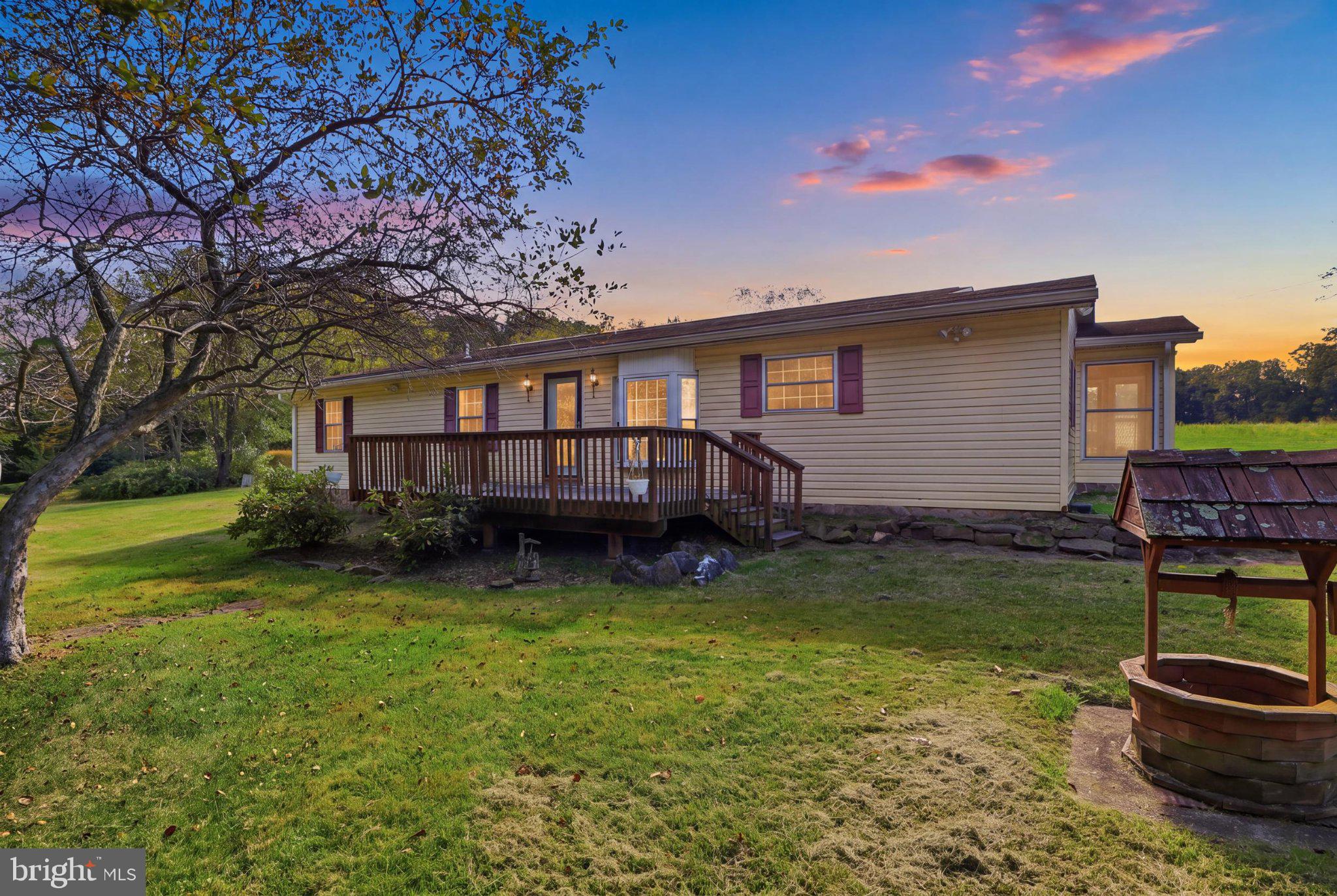 Located on a generous 2.6 acre lot this charming home is ready for immediate purchase.   The tranquil rural setting is partially wooded and mostly clear with fantastic country views and beautiful daybreaks.   The outdoor space includes a gazebo, 2 large outdoor sheds, paved driveway and oversized 2 car garage.  What stands out immediately as you walk in the home is the space.  Over 2000 square feet including a versatile second kitchen/hobby room, large dinging and living rooms, and 3 full baths.  Also includes attractive bamboo flooring, main level laundry and central heat/air.   The utility room is located in a dry basement for extra storage which includes a chairlift.  Solar panels and a generator provide extra savings and peace of mind in case out a power outage.  Experience the best of both worlds with peaceful rural living with easy access to community conveniences.