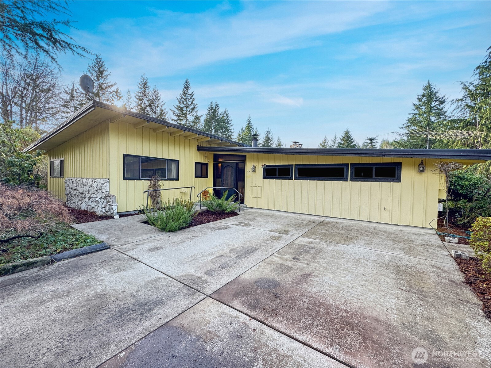 Just minutes off Hwy 12, this Randle home sits on a private 2-acres backing to beautiful Silver Creek. Inside this classic mid-century layout is an entryway with stone accents and a wood stove. An open kitchen flows into the living room with a rock fireplace. Access the upper deck which overlooks the property. The spacious primary has a full bath. Three more bedrooms and a remodeled bath with a roll-in tile shower on the main floor. The daylight basement adds a bonus room, bathroom, laundry with sink, and a wood stove.  A slider opens to the patio and in-ground pool. Fully fenced acreage includes fruit trees, gardening space, garage and a carport. STMU zoning adds potential. NO HOA. Easy access to the national forest and town amenities.
