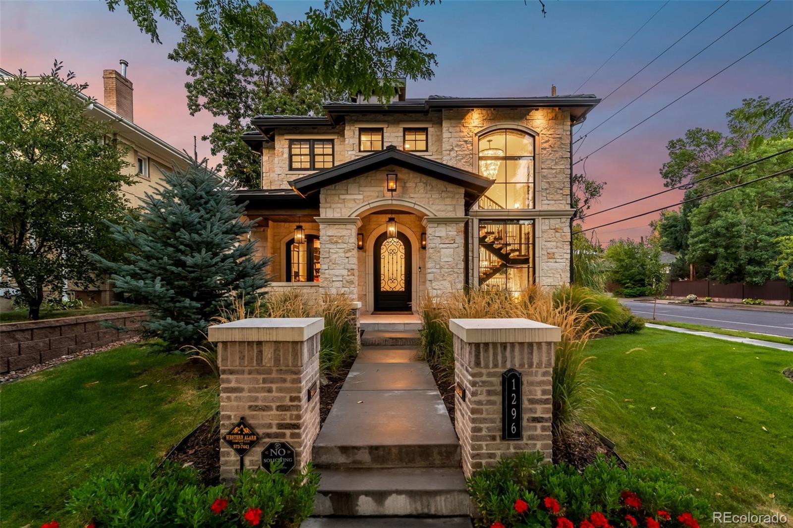 Striking modern architecture meets elevated functionality in this East Wash Park stunner, designed for those who appreciate luxury, space, natural light, and architectural detail.Situated on a prominent corner lot just blocks from South Gaylord Street, this limestone residence blends architectural presence with refined modern living. Spanning over 6,000 square feet, the home is defined by dramatic lines, custom craftsmanship, and walls of glass that dissolve the boundary between indoors and out.The main level showcases 10-foot coffered ceilings, a statement floating staircase, and seamless indoor-outdoor flow to a covered patio with overhead heating and built-in gas fireplace. The kitchen features Sub-Zero and Wolf appliances, dual quartz islands, and thoughtful custom cabinetry. Upstairs, four bedrooms include a serene primary suite with steam shower, soaking tub, walk-in closet, and built-in morning bar. A third-floor flex suite with full bath opens to a west-facing rooftop deck with skyline views—ideal for guests, au-pair, home office, gym or party room.Downstairs, 11-foot ceilings elevate the fully finished basement, which offers a large recreation room, wet bar, gym, guest bedroom, and full bathroom.Originally completed in 2021 by respected local luxury builder Cline Design Group, the home has since been elevated with over $200,000 in upgrades including bespoke window coverings throughout, a fully integrated AV and Control4 smart-home system, and a Culligan whole-house water filtration system with reverse osmosis. 240V outlet in the oversized garage provides EV charging capabilities.Every detail, such as the full limestone exterior facade and cement tile roof, speaks to quality and intention, offering a residence that balances timeless design with contemporary sophistication in one of Denver’s most established neighborhoods.